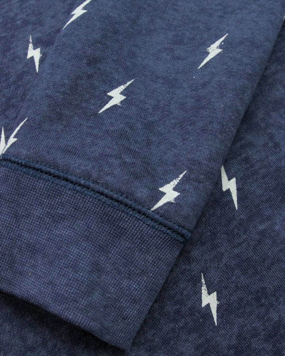 Close-up of Appaman's Thunderstorm Revel Crewneck featuring playful lightning bolt prints in a stylish navy hue.