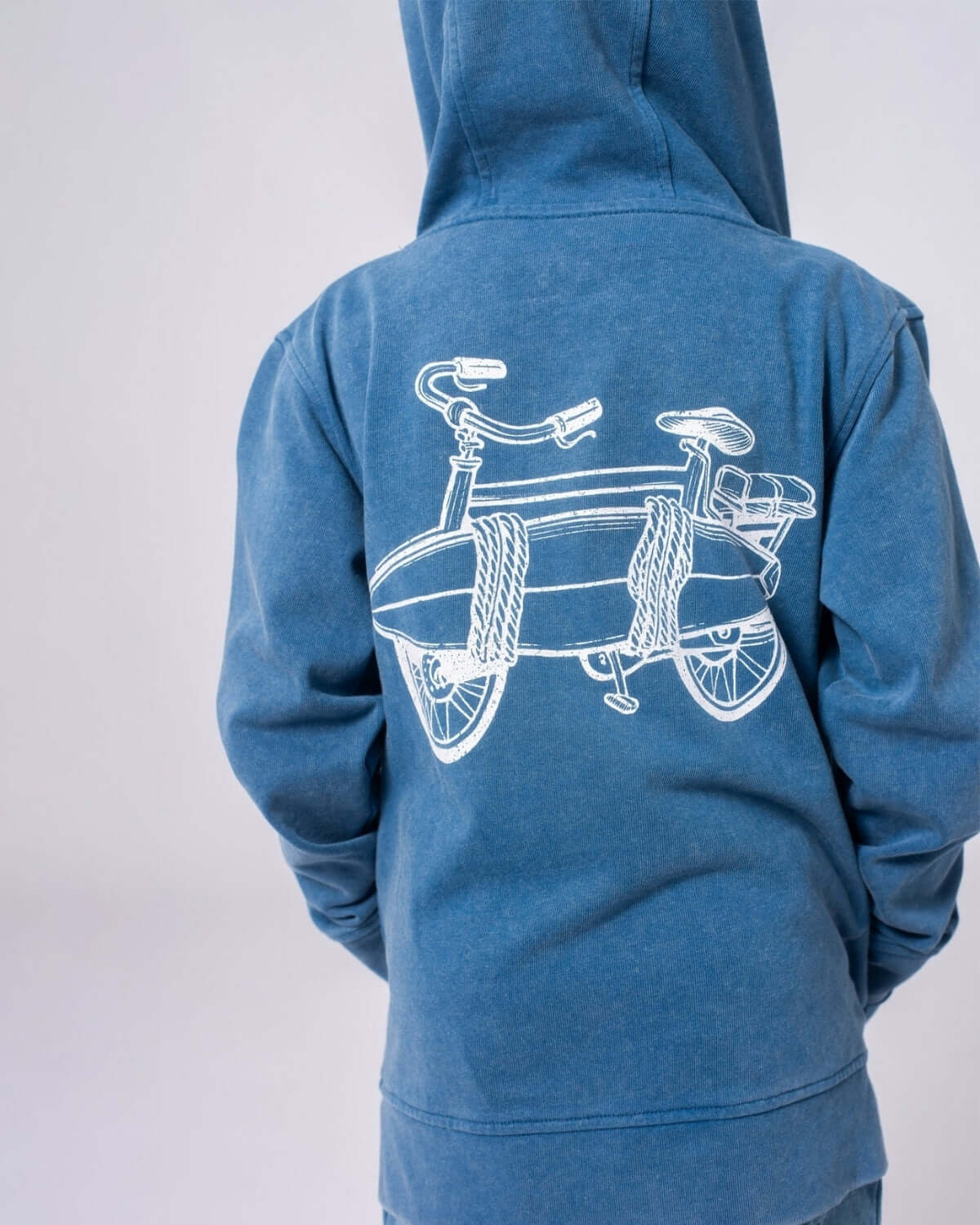 Cool kids hoodie in sunwashed blue featuring a fun bike and surfboard illustration—perfect for school and weekend adventures!