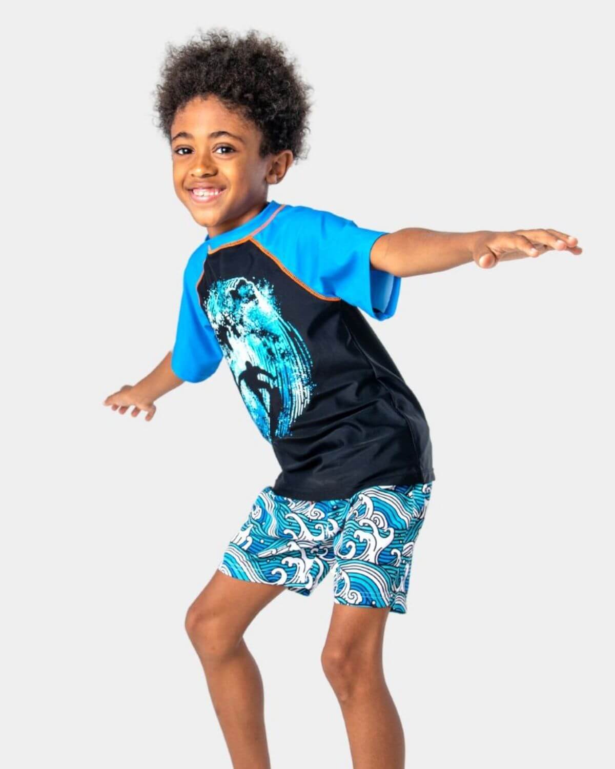 Child wearing a Surfer Wave Blue Rash Guard with UPF 50+ protection ready for warm weather fun.