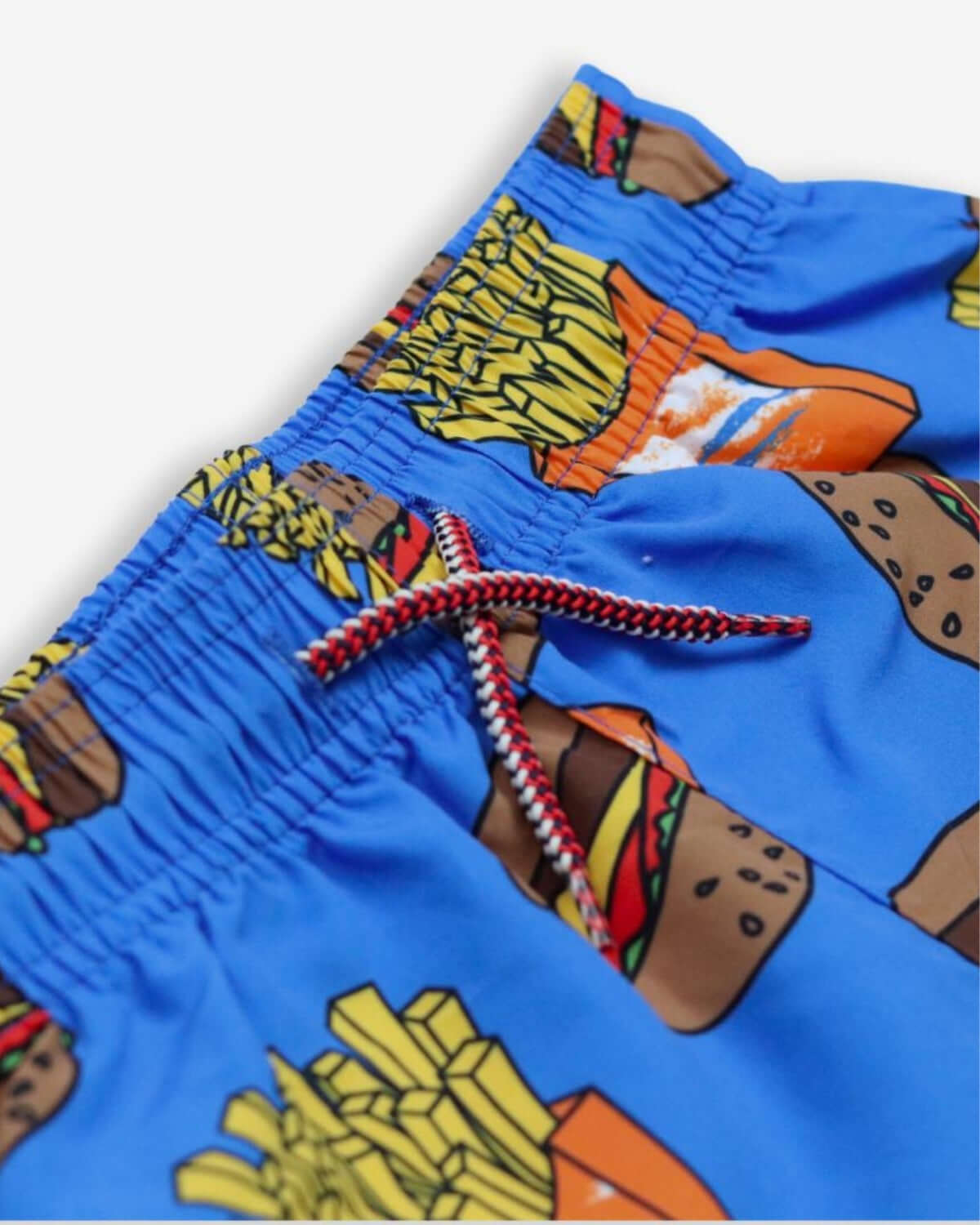Close-up of Appaman's fun Burgers & Fries Swim Trunks, perfect for stylish summer play in durable kids clothes.