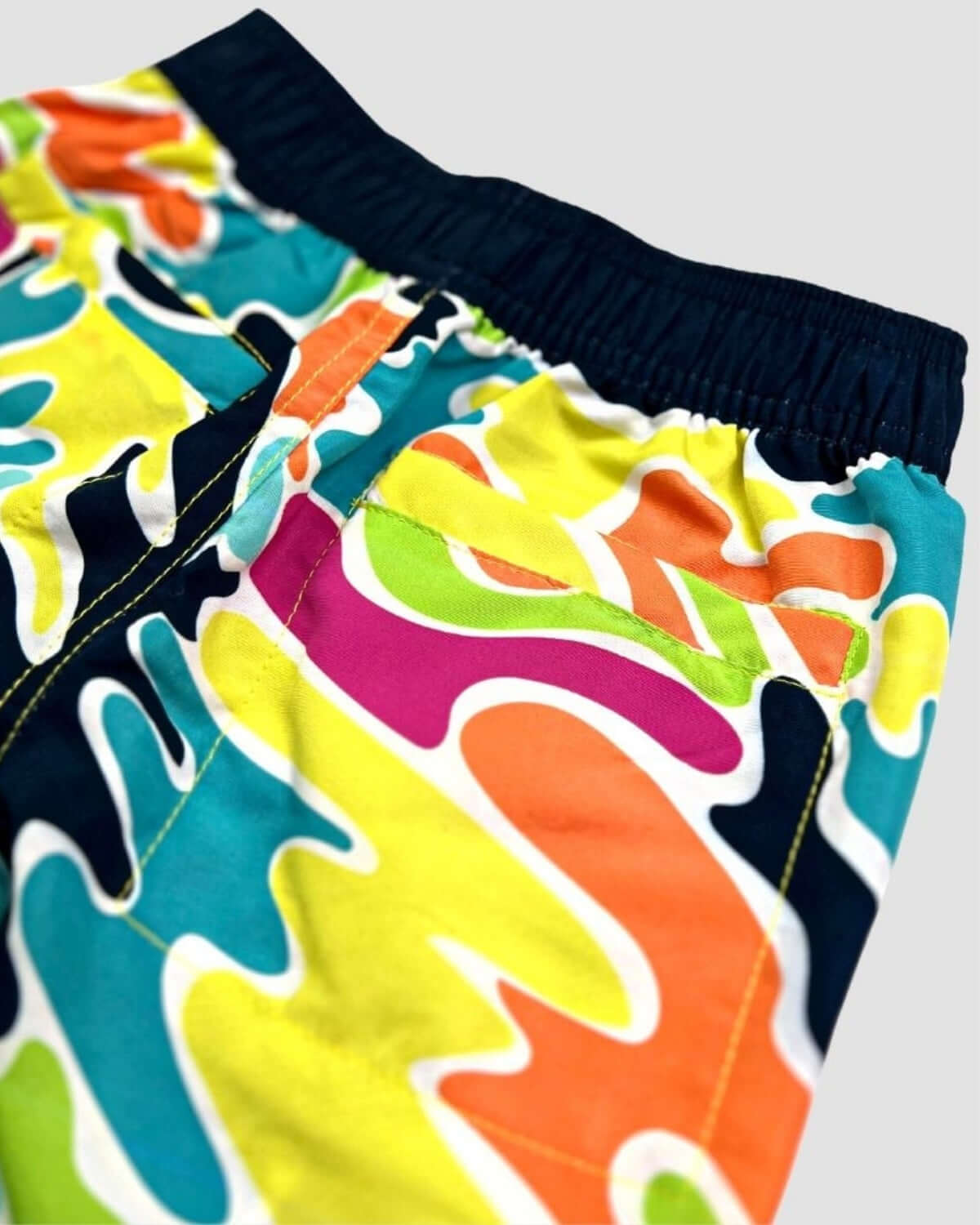 Color Spill Swim Trunks showcasing a vibrant pattern ideal for beach or pool activities.