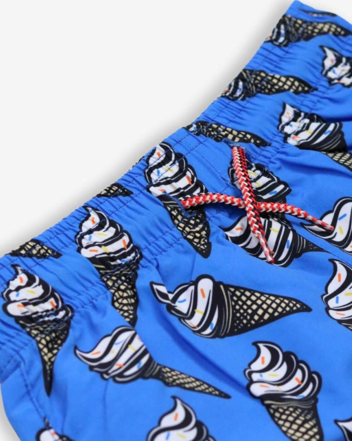 Vibrant blue swim trunks with playful ice cream cone print, perfect for stylish summer fun in high-quality kids clothes.