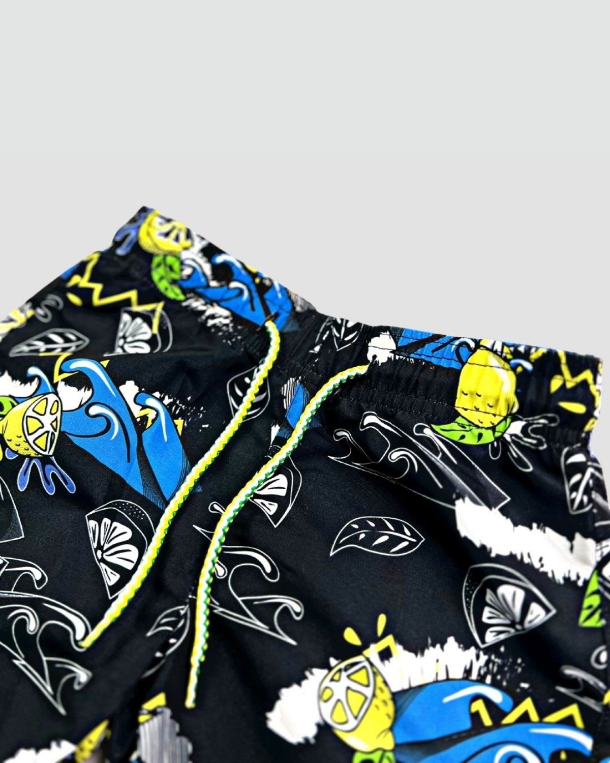 Vibrant Lemon Chill Swim Trunks for kids, featuring playful waves and citrus graphics—ideal for summer fun and stylish beach days!
