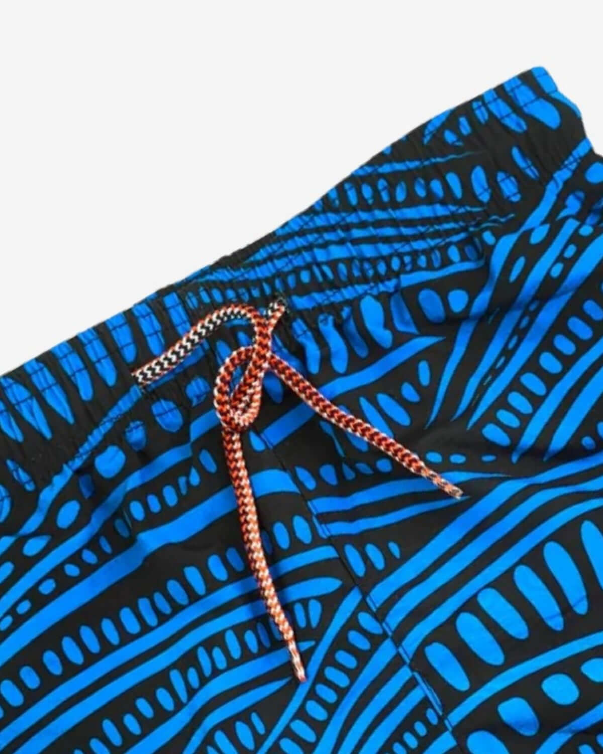 Vibrant blue wave-pattern swim trunks with an elastic waistband, perfect for stylish kids' beach days.