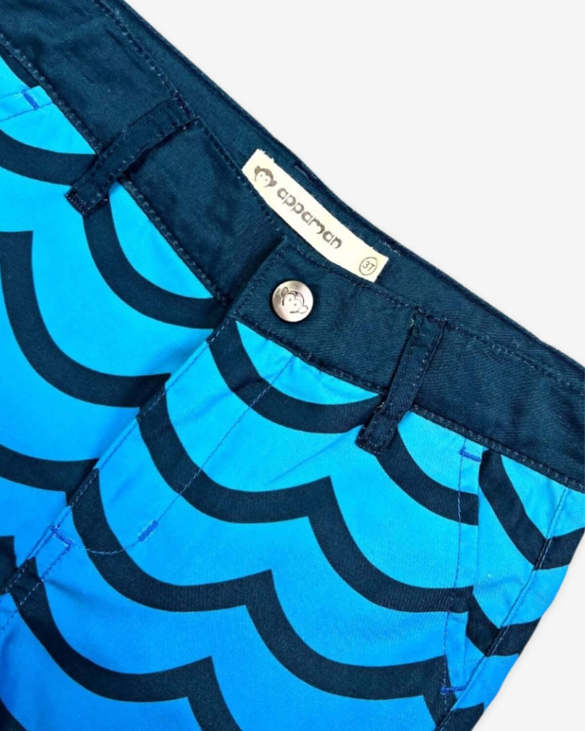 Close-up of the waistband and fabric of Wavy Blue Hybrid Swim Shorts, showcasing its playful design and tailored features.