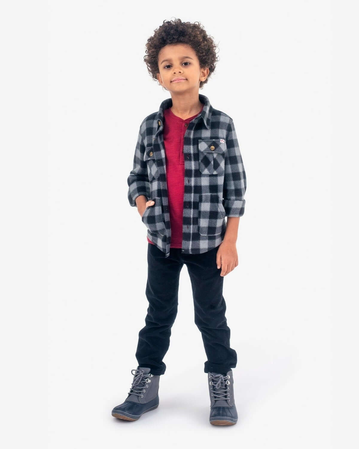 Black Check Snow Fleece Shirt on a young boy, featuring plaid design, perfect for winter adventures.