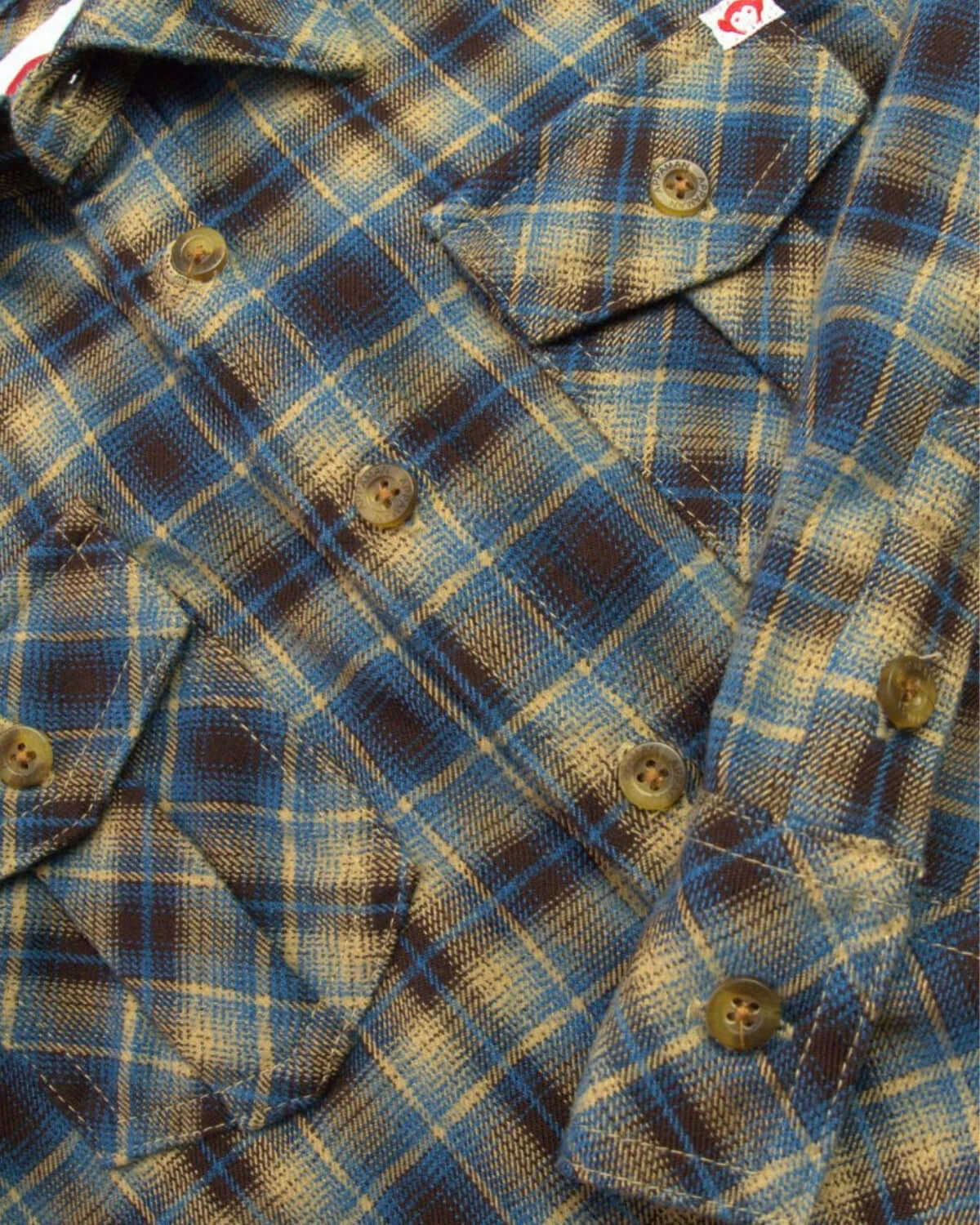 Vibrant chocolate and blue plaid flannel shirt, perfect for stylish boys' back to school outfits.