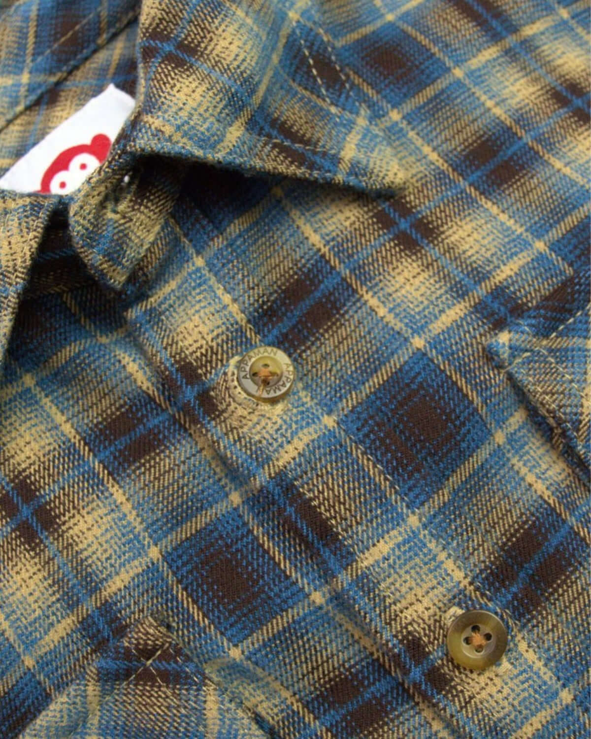 Close-up of a cozy chocolate and blue plaid flannel shirt, perfect for stylish boys' back-to-school outfits.