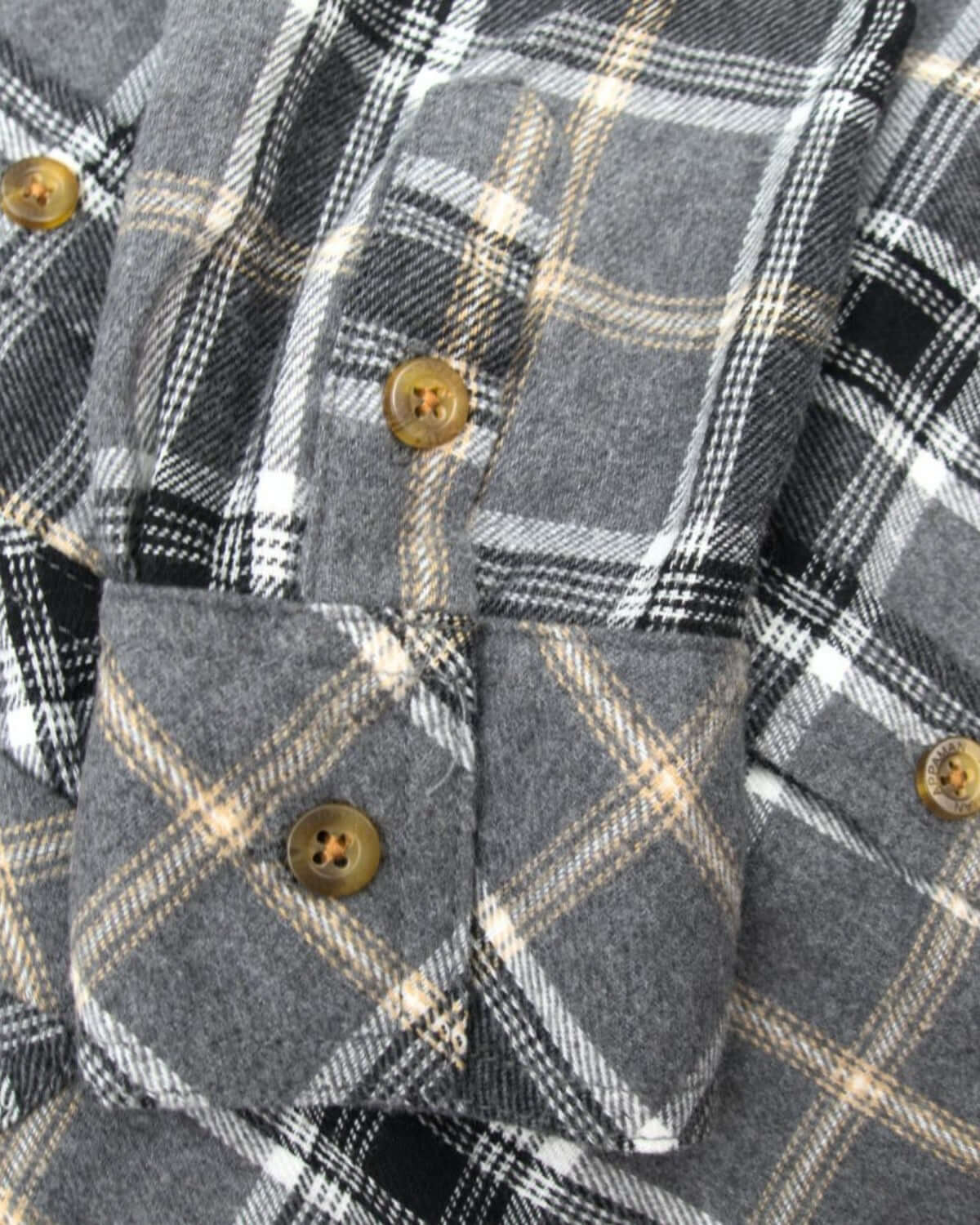 Soft greige plaid flannel shirt with stylish buttons, perfect for kids' fall adventures in cozy comfort.