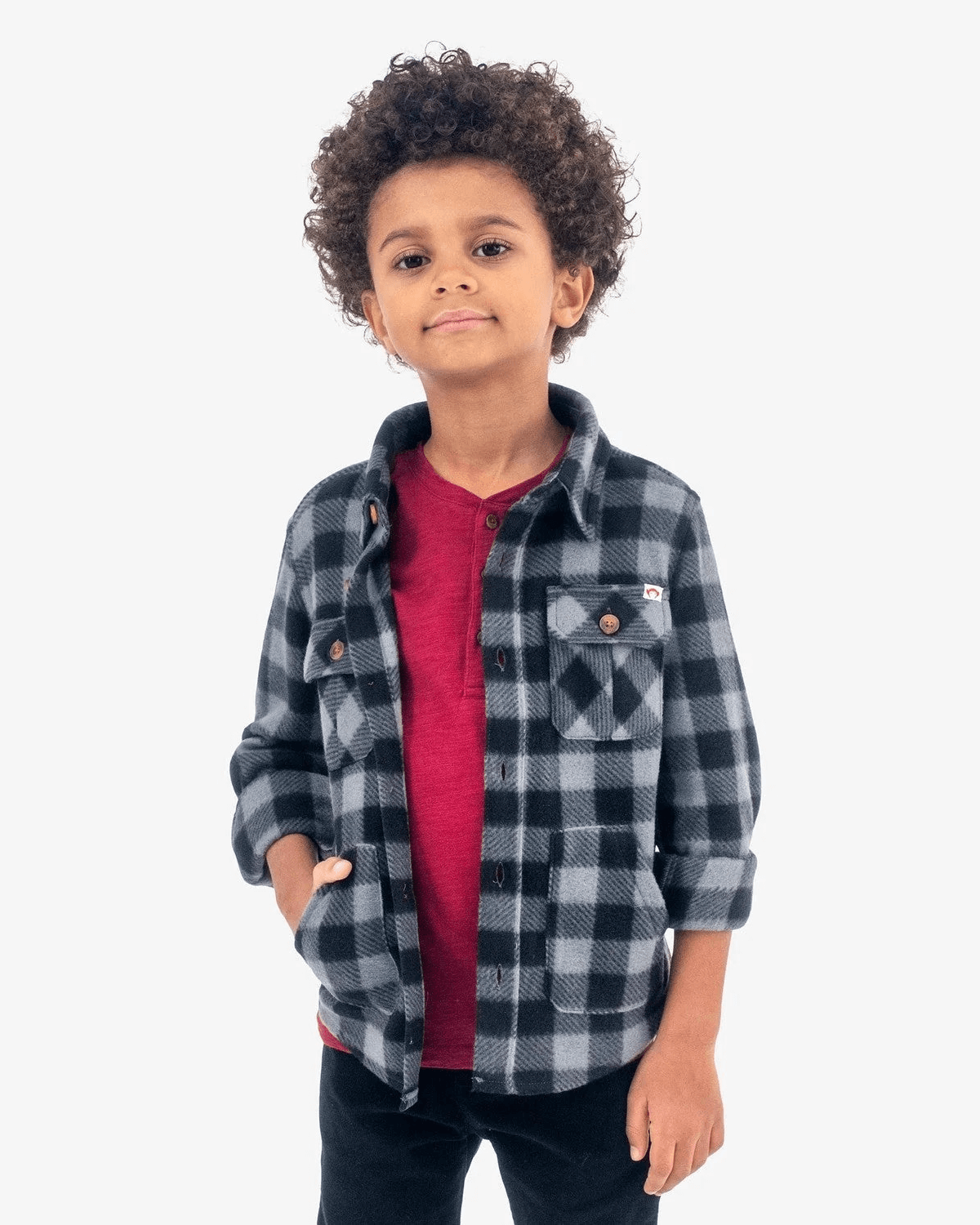 Trendy boy sporting a cozy grey/black check snow fleece shirt, ready for winter adventures in style!