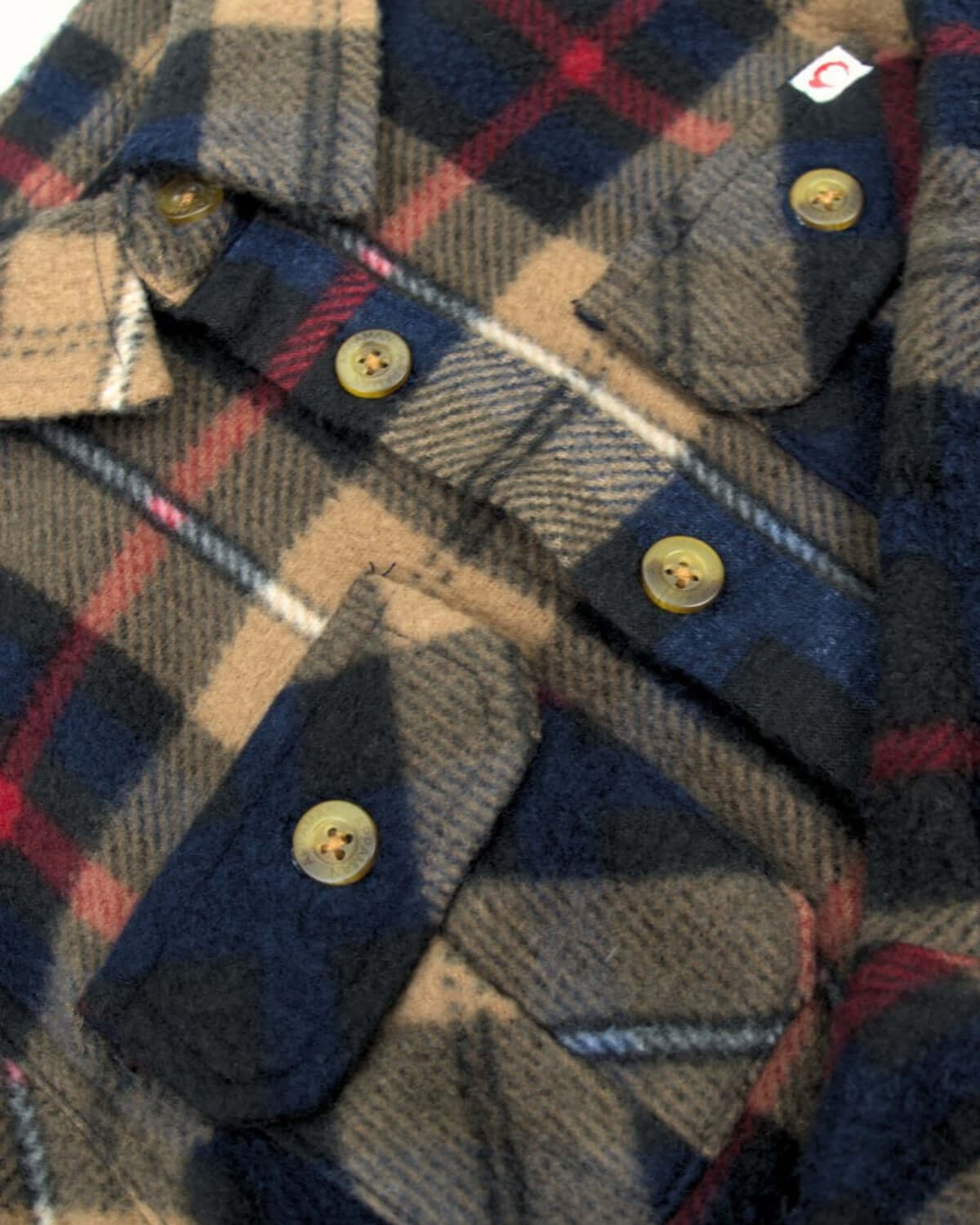 Navy and khaki plaid snow fleece shirt with cozy buttons—stylishly warm for kids' winter adventures!