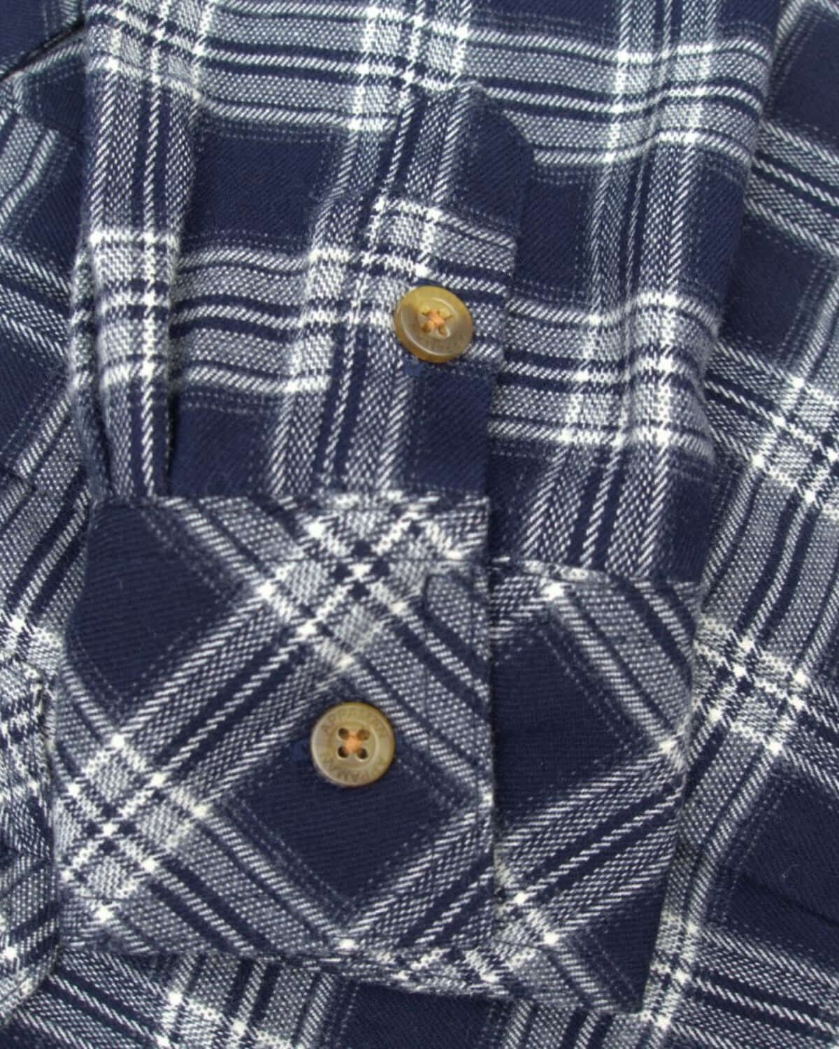 Close-up of Appaman's Navy Plaid Flannel Shirt, featuring quality buttons and classic cotton texture, perfect for kids' fall adventures.