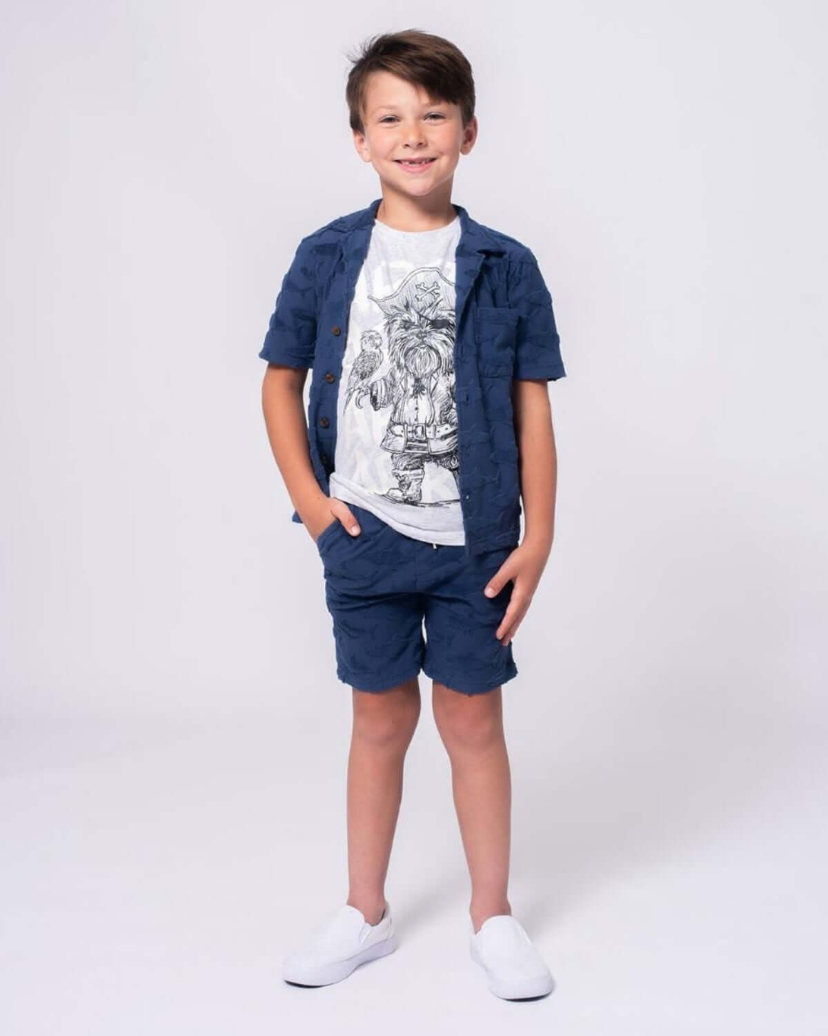 Stylish boy in navy shark resort shirt and shorts, perfect for fun beach days and back to school adventures!