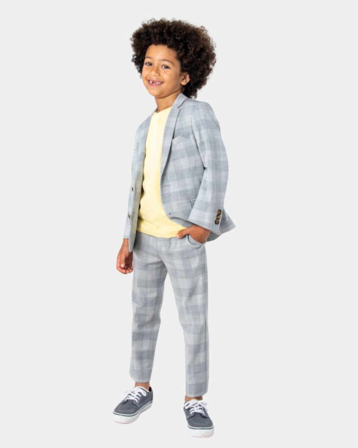 Stylish boy rocking a plaid suit with a pale yellow shirt—ideal for family events or chic back-to-school vibes!