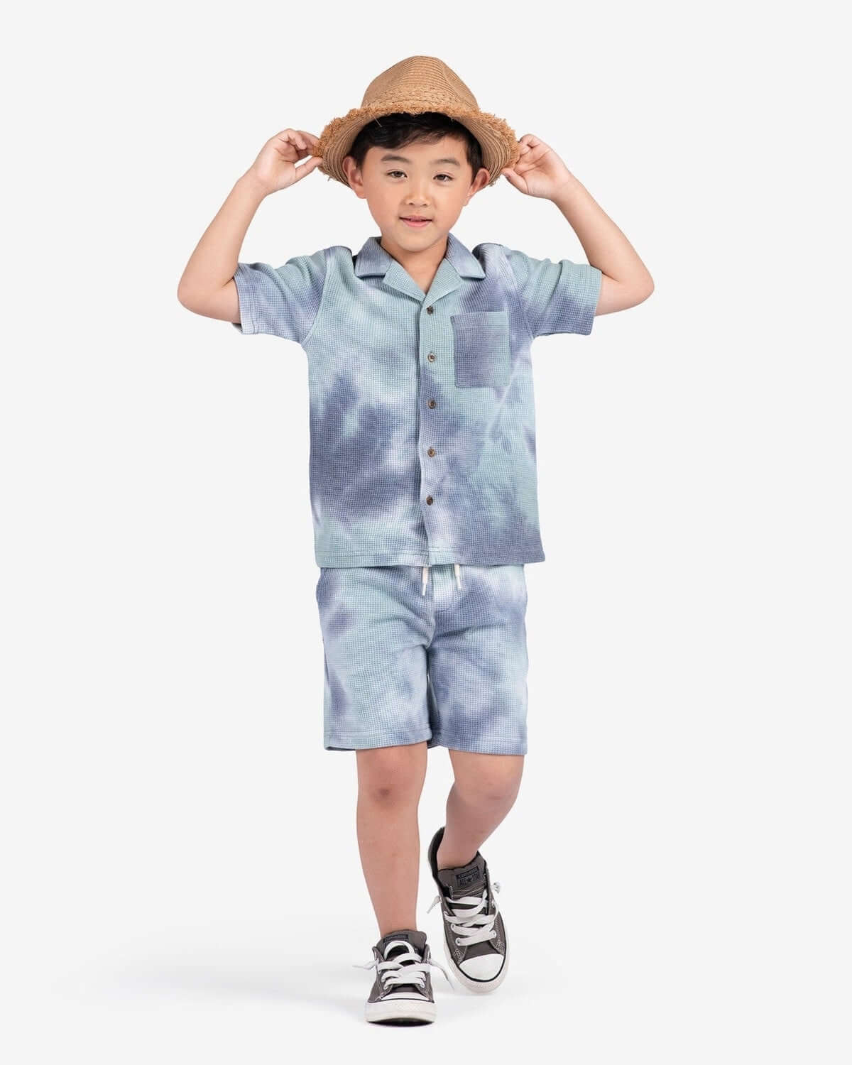 Boy wearing Seafoam Resort Shirt and Seafoam Resort Shorts, enjoying summer vibes in tie-dye style.