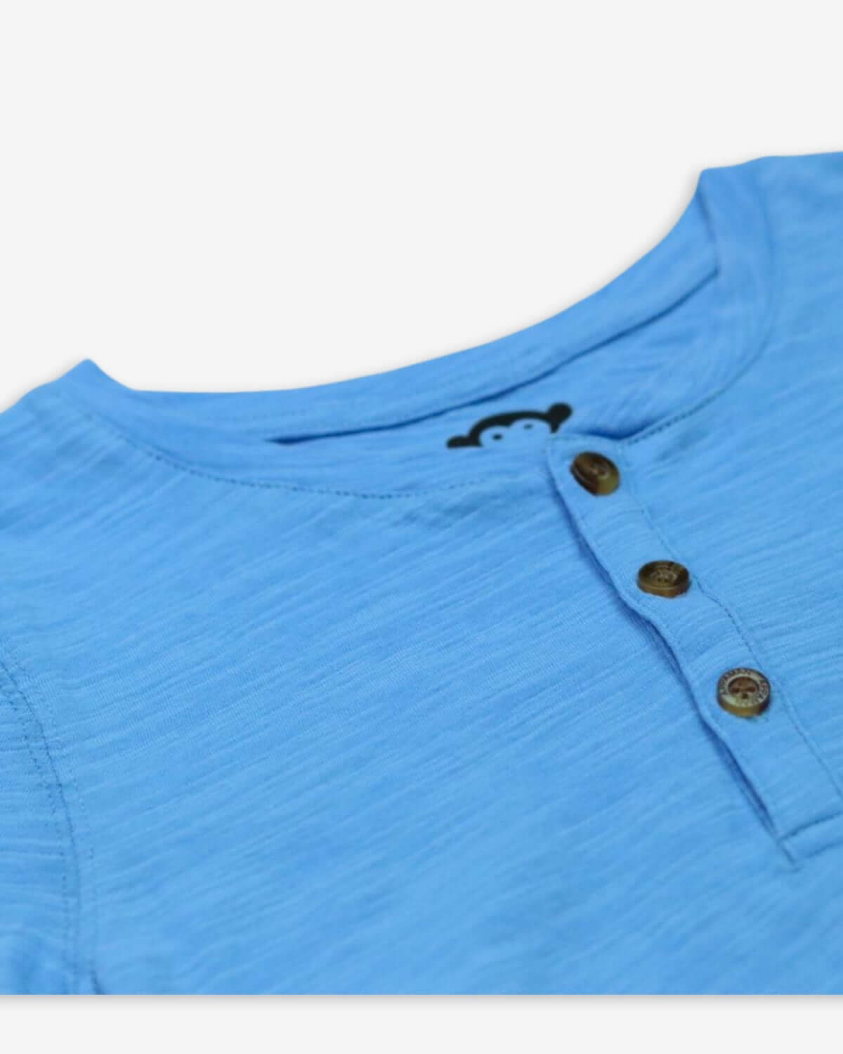 Close-up of a sky blue Henley shirt featuring stylish buttons, perfect for trendy kiddos!