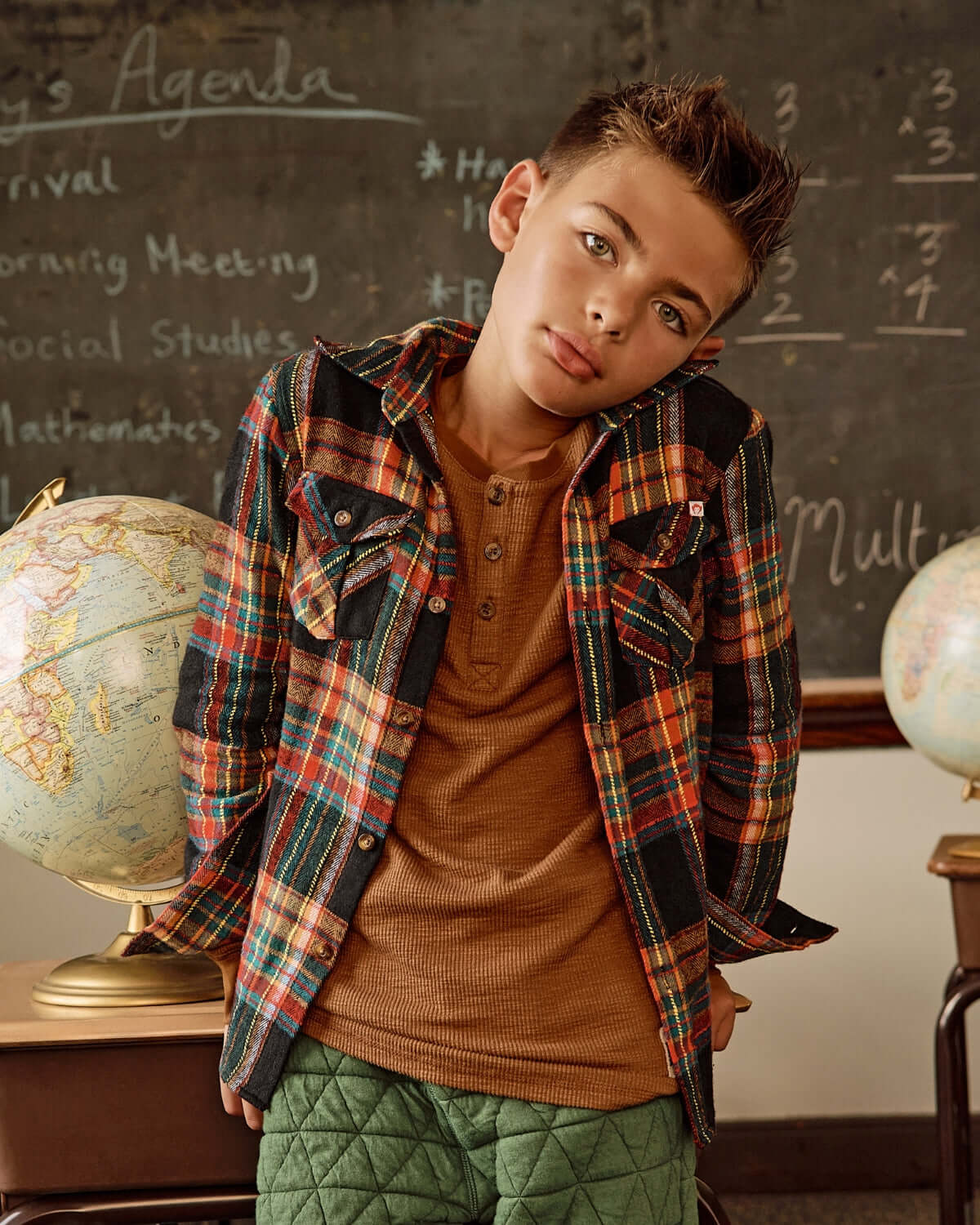 Cool kid rocking a vintage tartan flannel shirt over a henley, ready for stylish back-to-school adventures!
