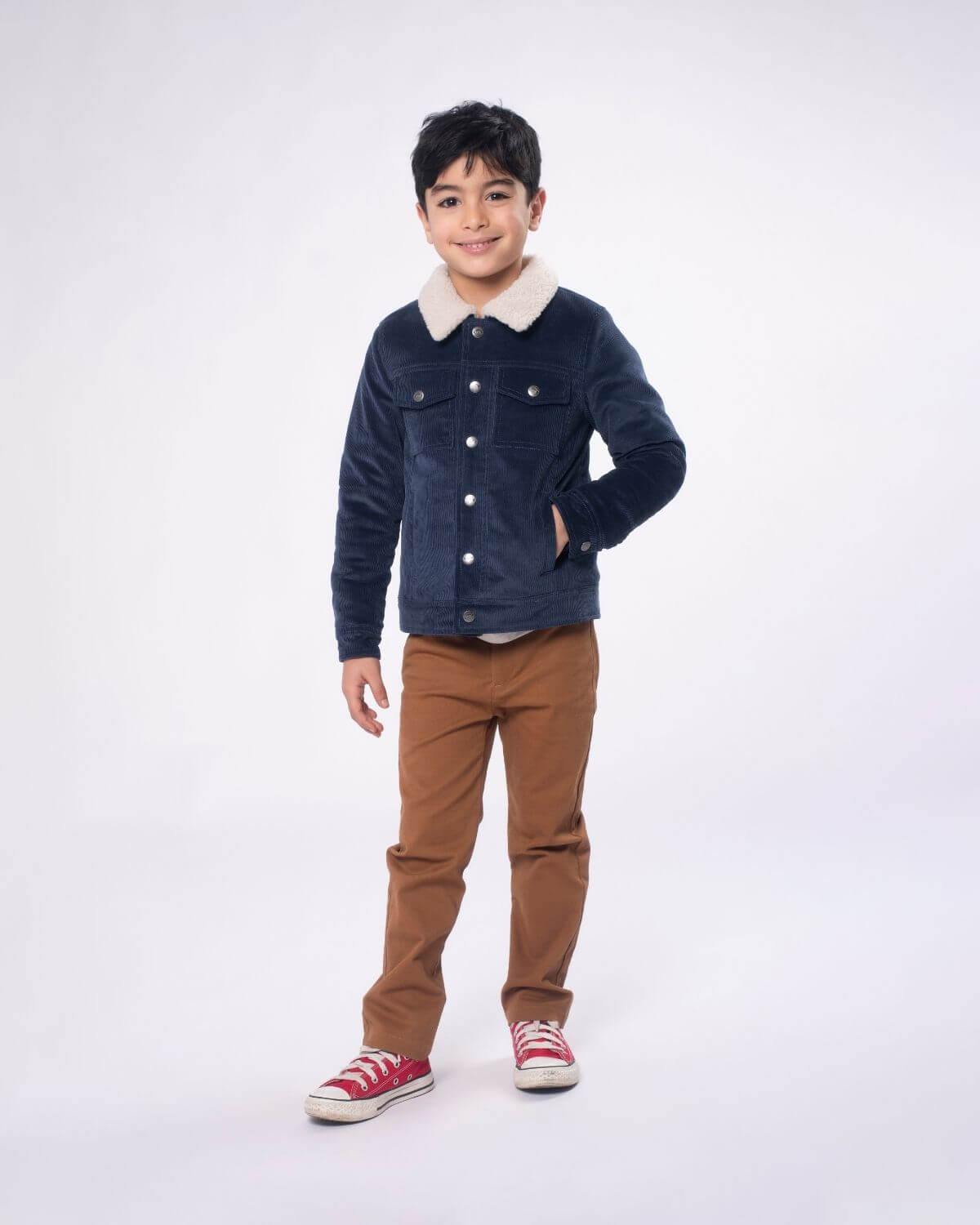 Stylish boy in navy cord jacket and khaki pants, ready for school or weekend adventures in high-quality kids clothes.