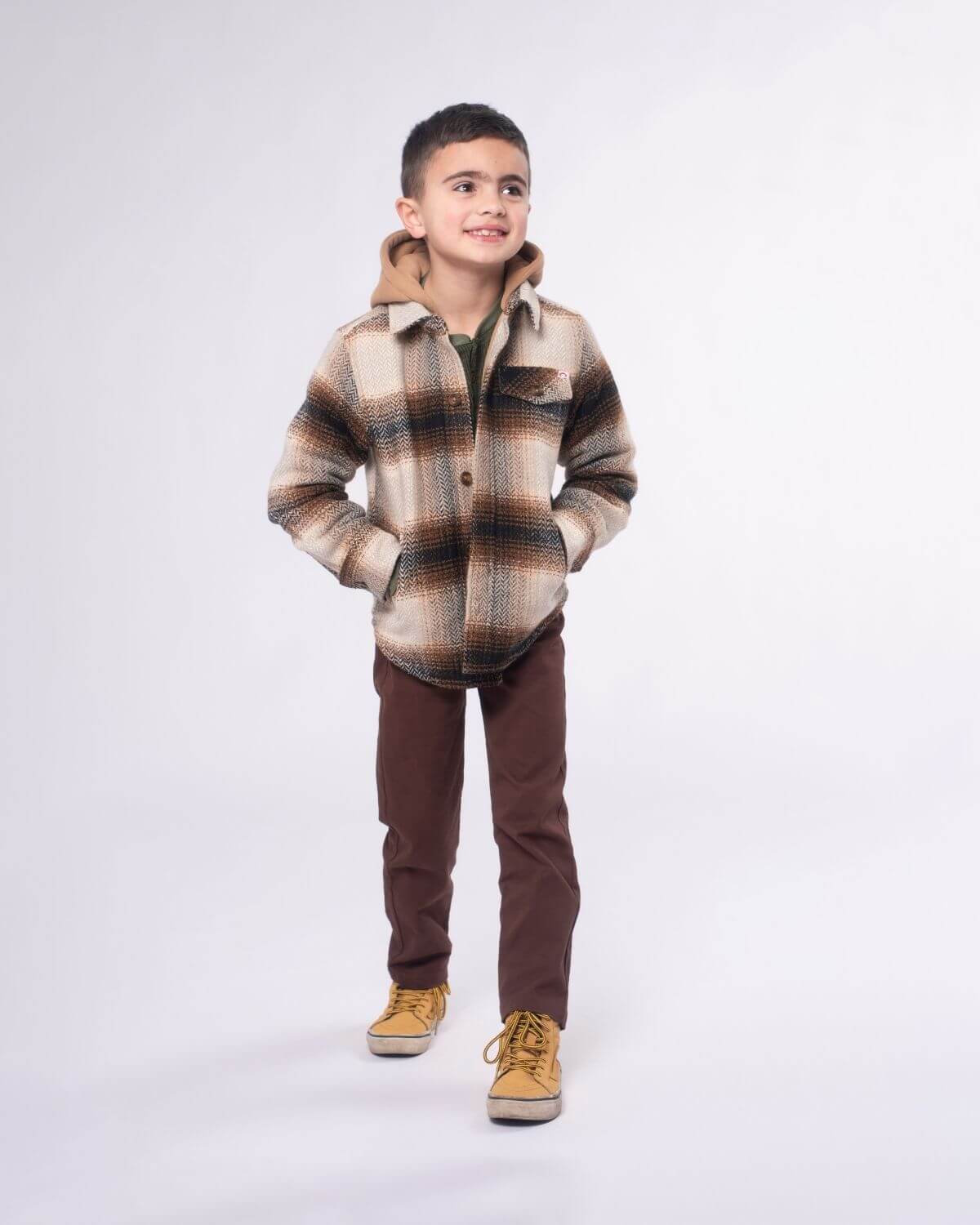 Stylish kid in a cozy plaid jacket and brown commuter twill pants, ready for fun everyday adventures. Perfect back to school look!