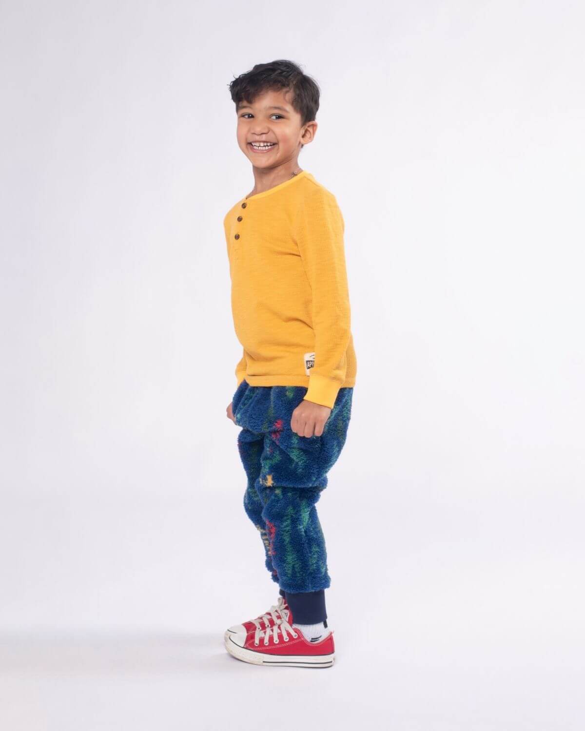 Stylish kid in mustard Craftsman Thermal Henley, ready for adventures in comfy kids clothes and playful hues.