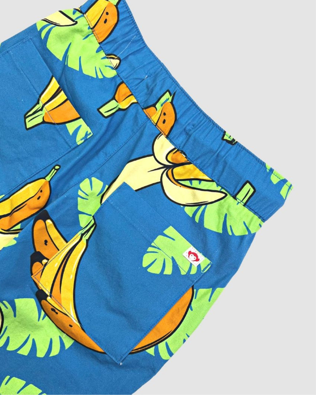 Fun blue Resort Shorts for kids, adorned with playful bananas and palms. Ideal boys' summer style, durable and stylish!