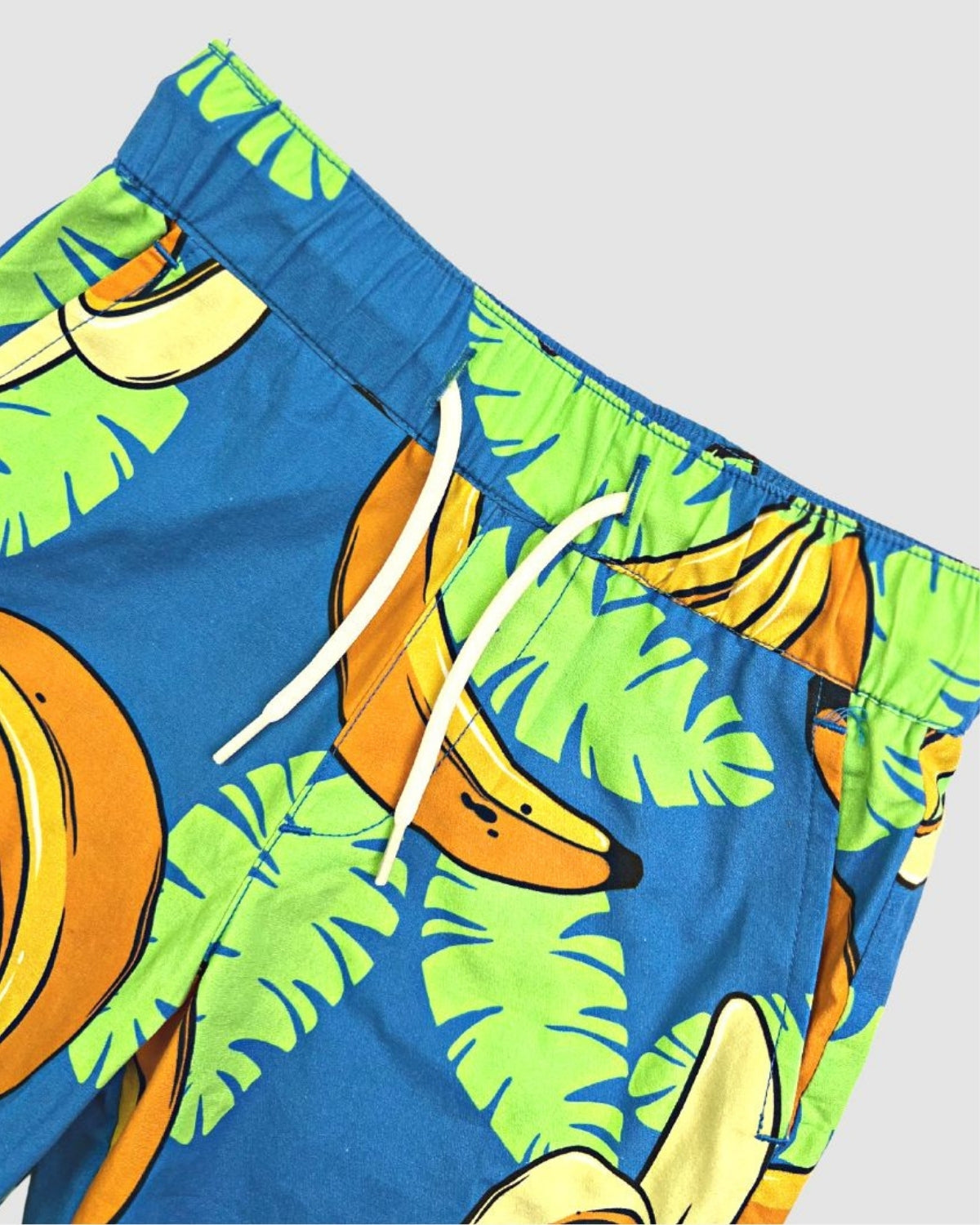 Vibrant boys' Bananas Resort Shorts featuring playful banana print and tropical leaves, perfect for stylish summer adventures!