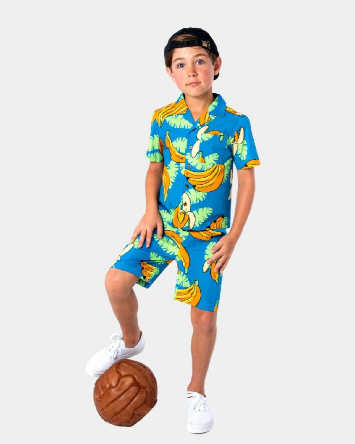 Stylish boy in vibrant Bananas Resort Shorts, perfect for playtime or summer adventures in kids' clothes.
