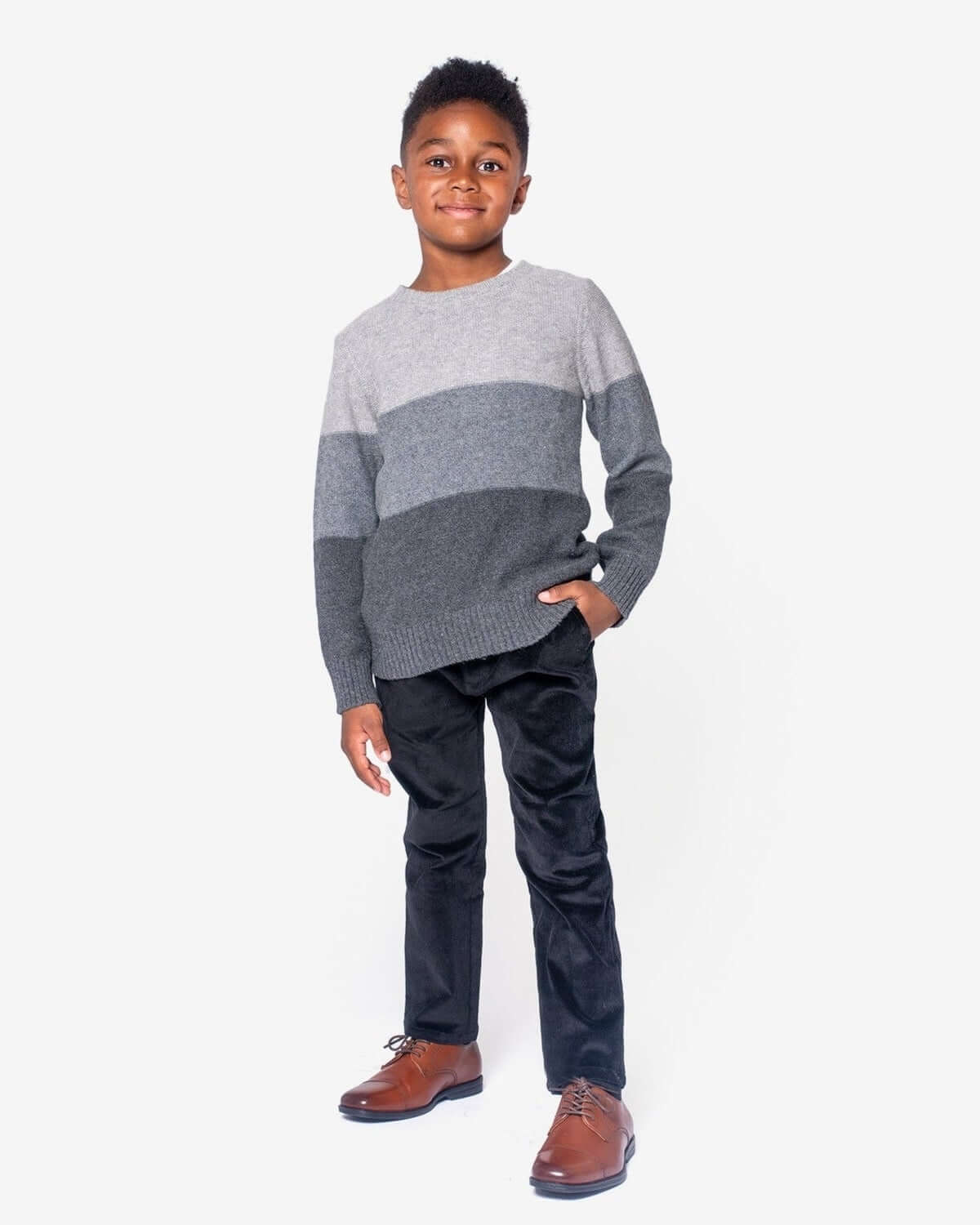 Stylish boy in a trendy gray striped sweater and black cord club pants, ready for back-to-school adventures!