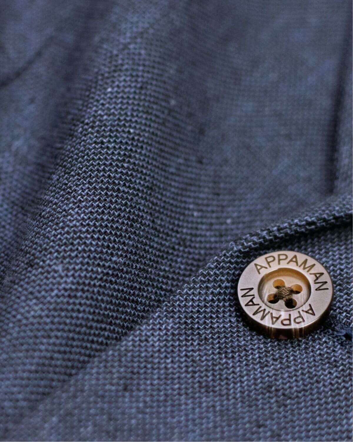 Close-up of Appaman button on premium Blue Nights fabric, showcasing high quality and trendy kids clothes for stylish adventures.