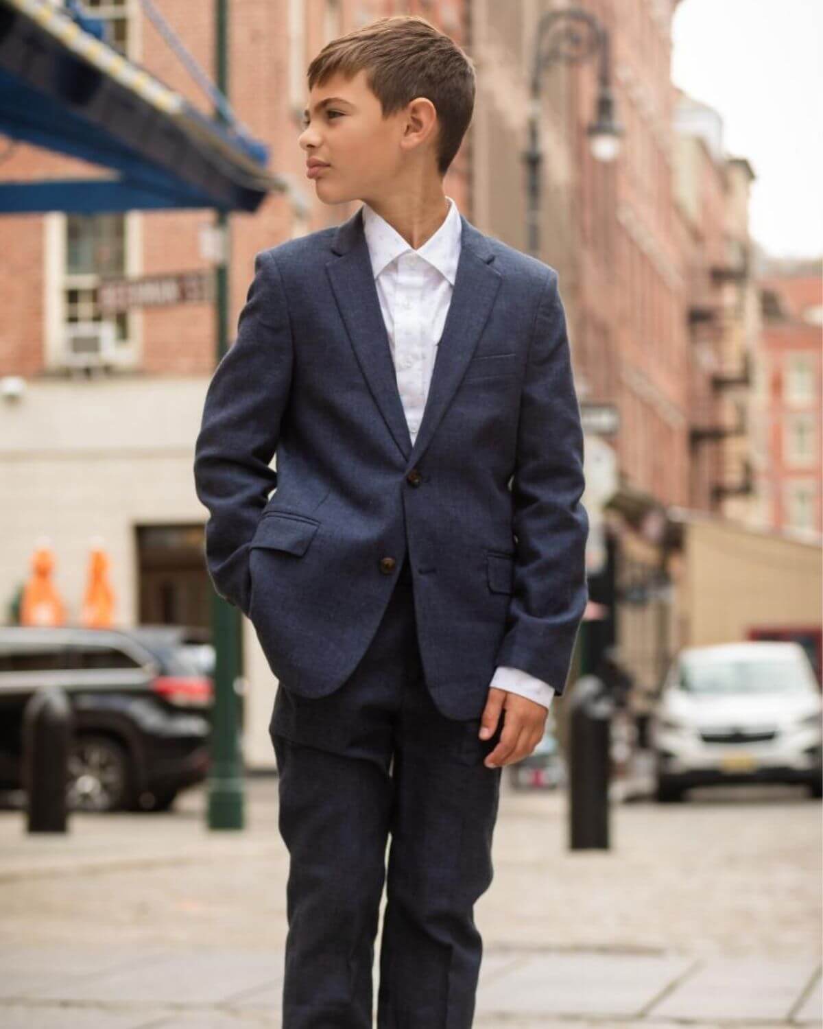 Stylish boy in a blue suit, blending modern flair with timeless elegance—ideal for special occasions and upscale kids clothes.