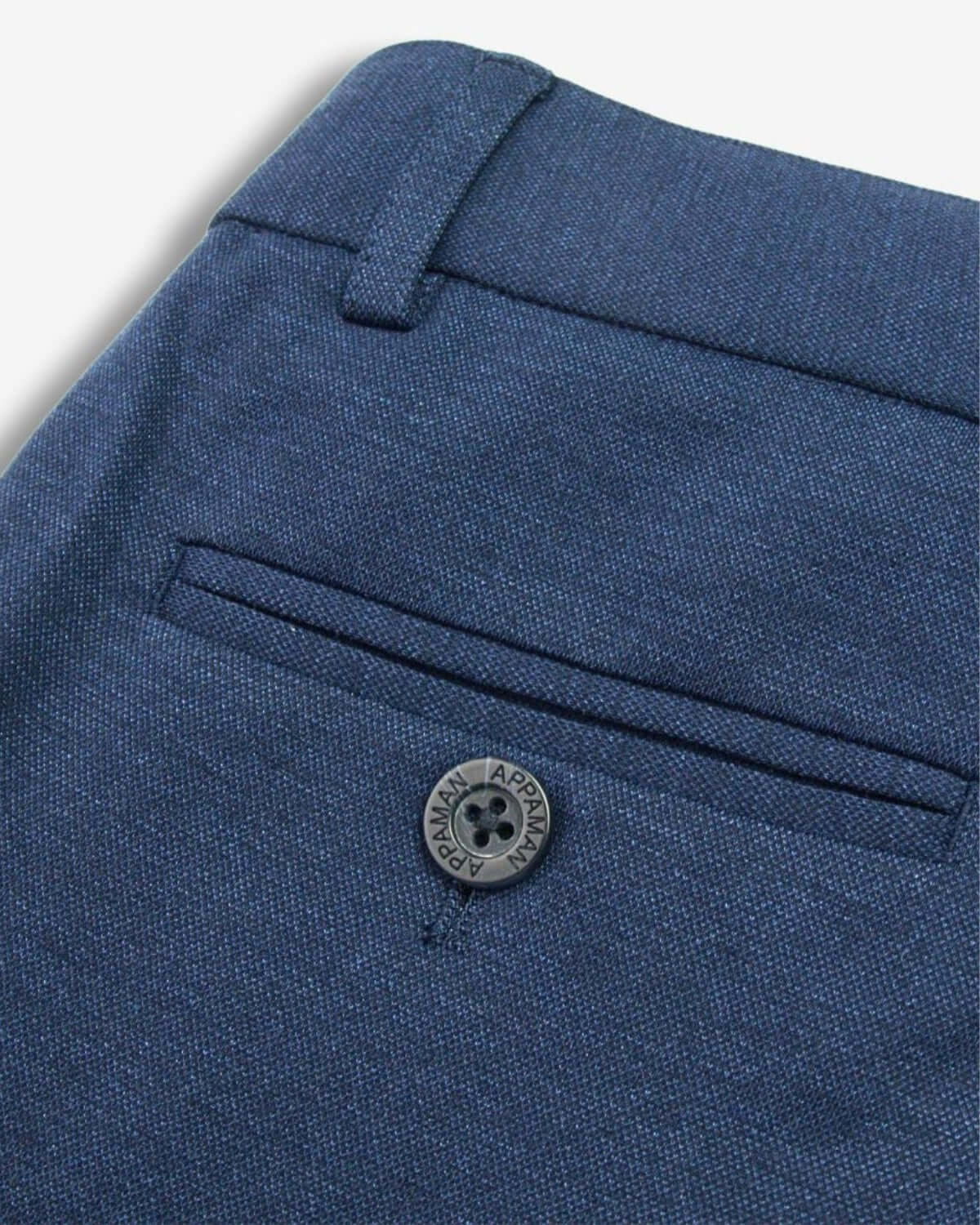 Close-up of Blueprint Stretchy Suit Pants featuring a back pocket and button detail.
