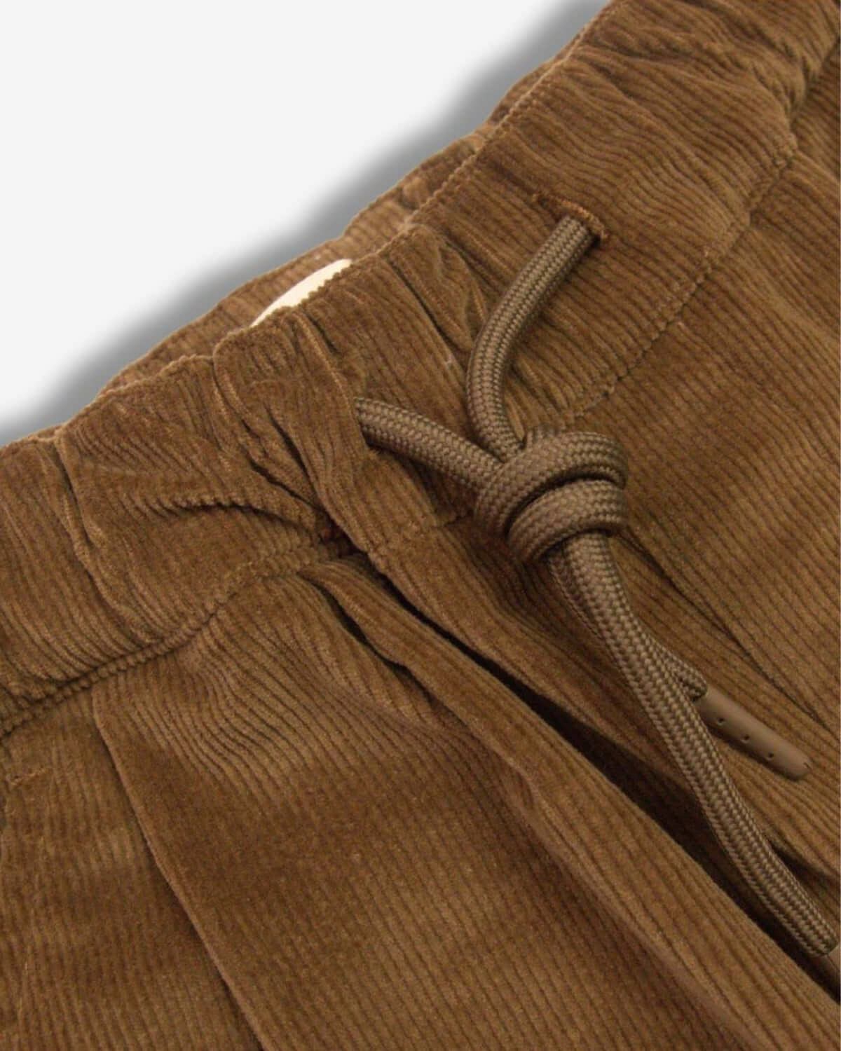 Close-up of British Khaki Club Pants showing stretchy waist and drawstring for comfy style in kids' fashion.