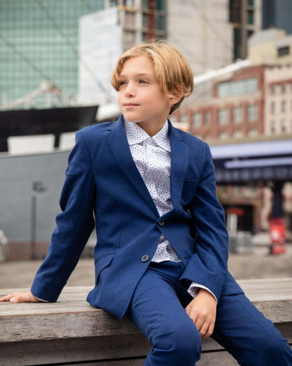 Young boy wearing Estate Blue Linen Stretchy Suit Pant and jacket, stylish look for special occasions.