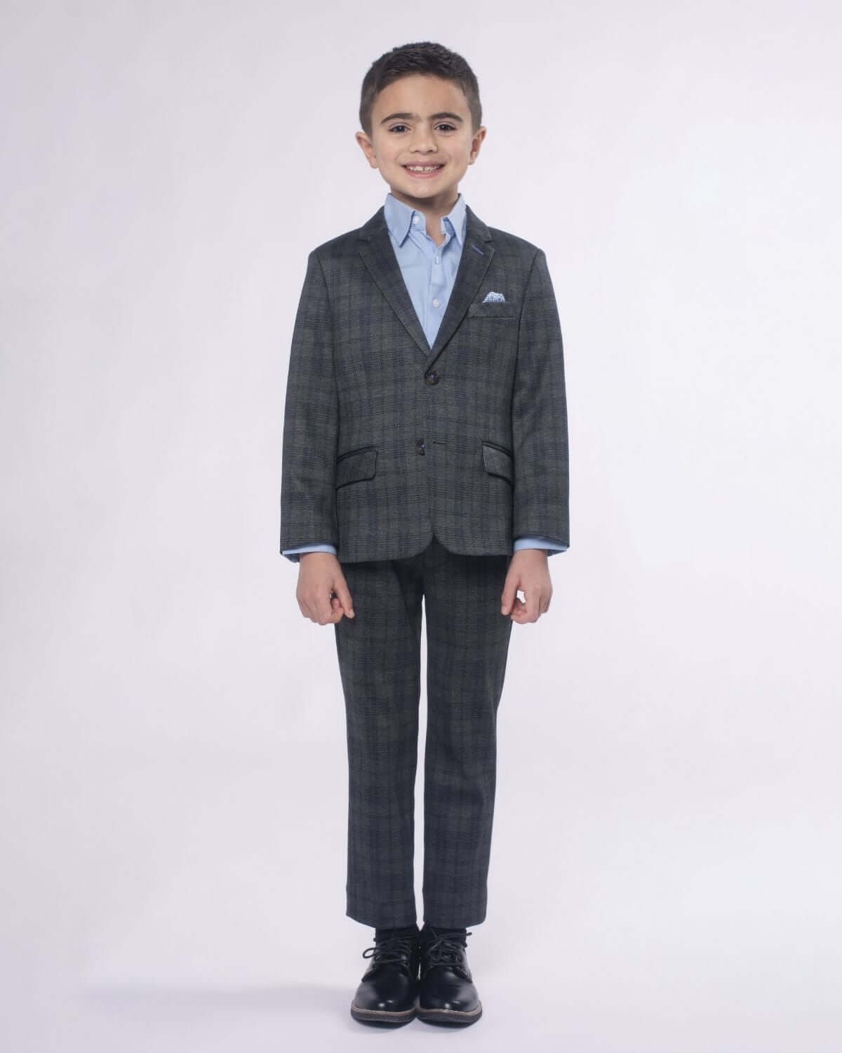 Dapper boy rocking Gentleman's Plaid Stretchy Suit Pants with confidence, ready for any special occasion in style.