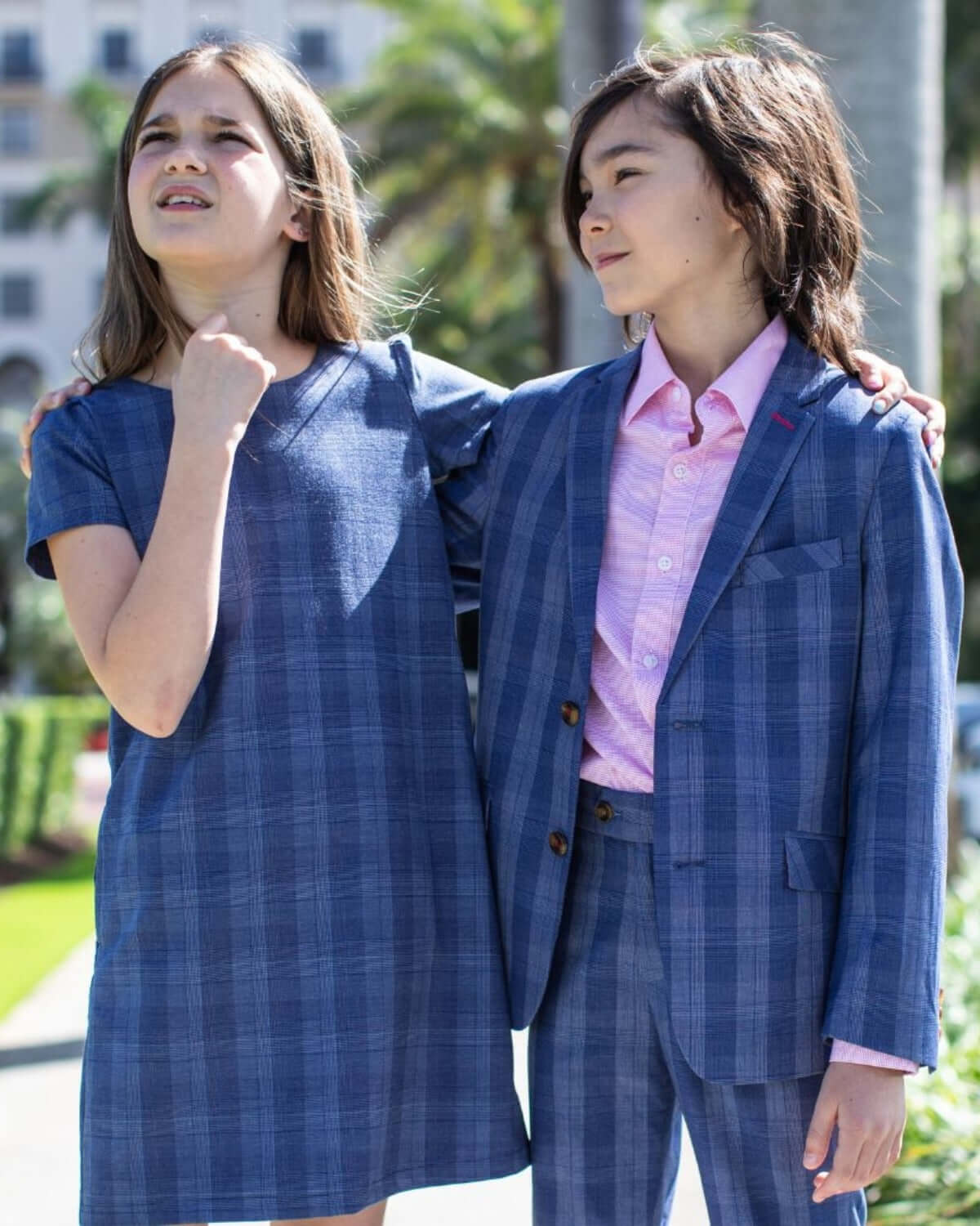 Trendy kids showcasing Indigo Glen plaid stretchy suit pants and stylish dress, perfect for back-to-school and special events.