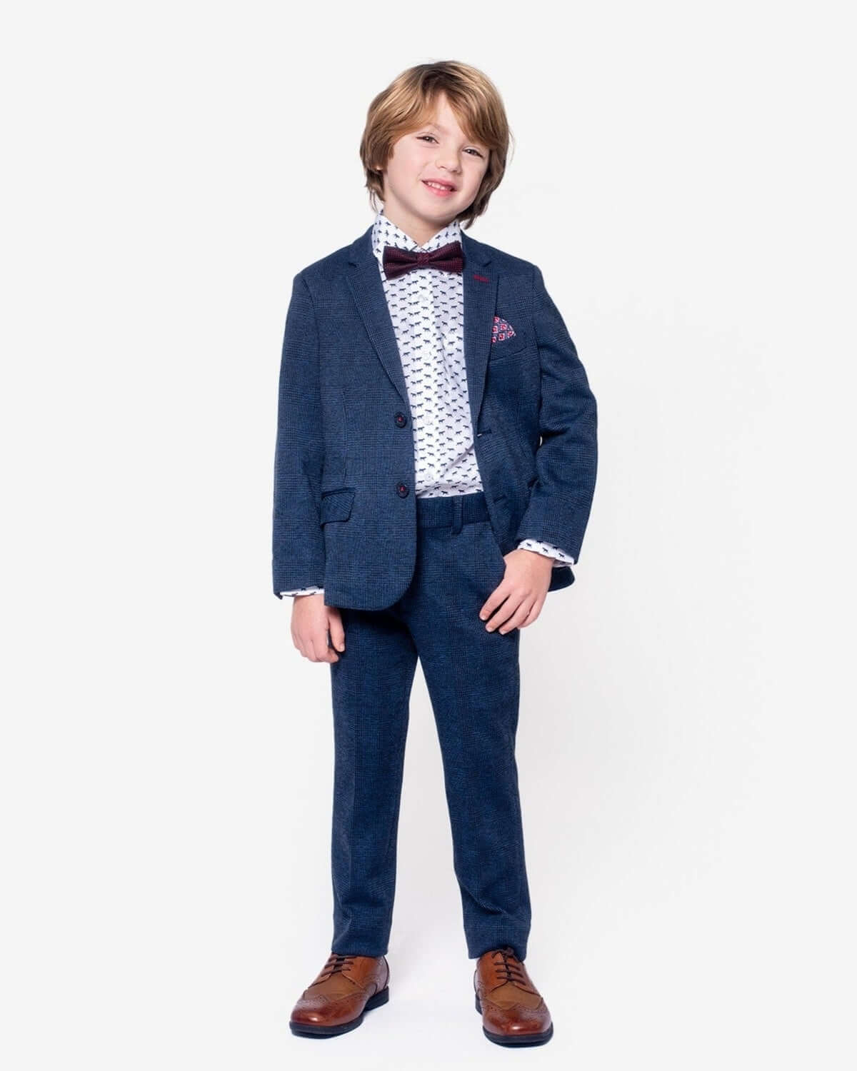 Boy wearing Indigo Wales Check Stretchy Suit Pants with a suit jacket and bow tie, perfect for formal occasions.