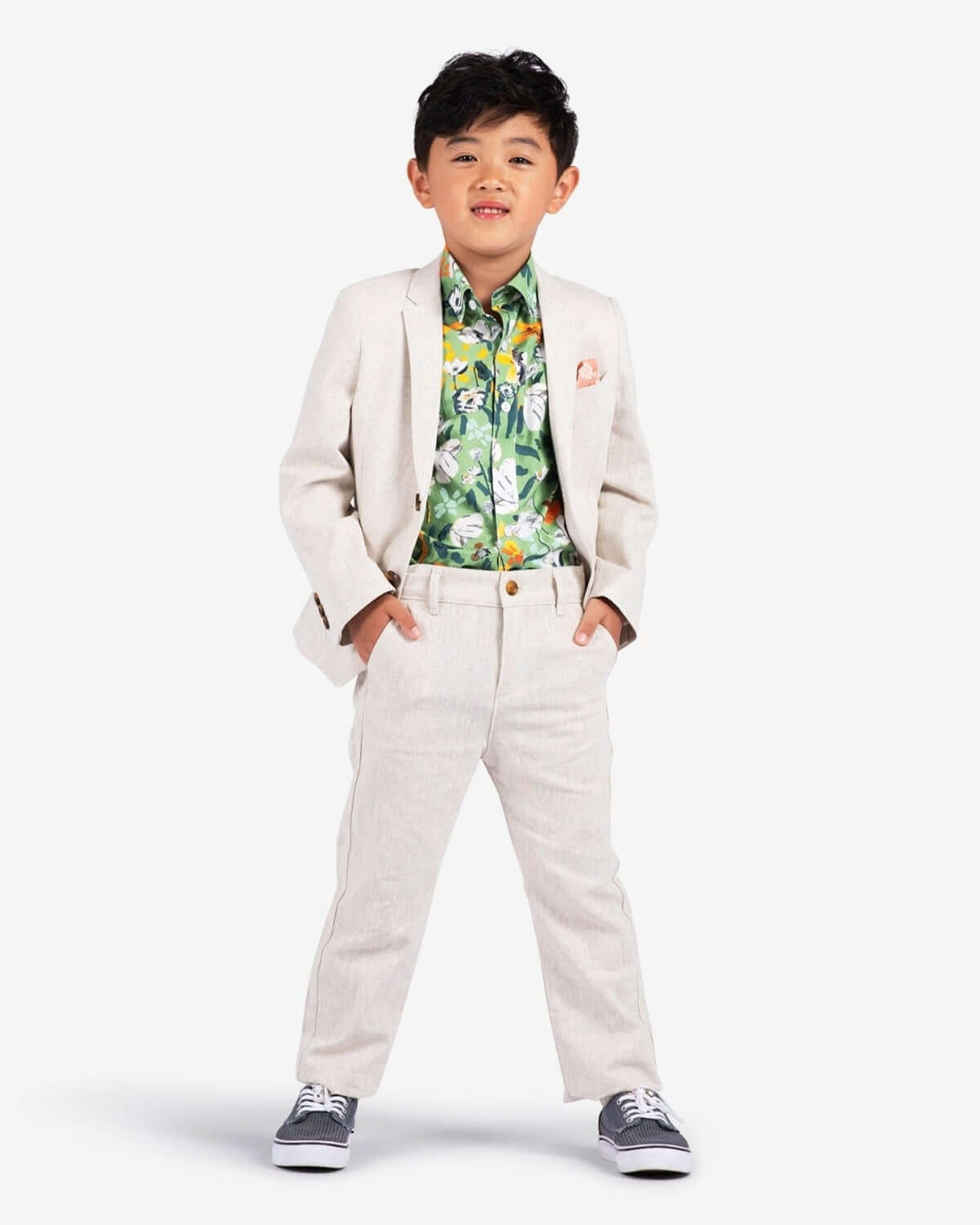 Stylish boy in a linen suit with a tropical shirt, rocking kids clothes that blend fun with sophistication!