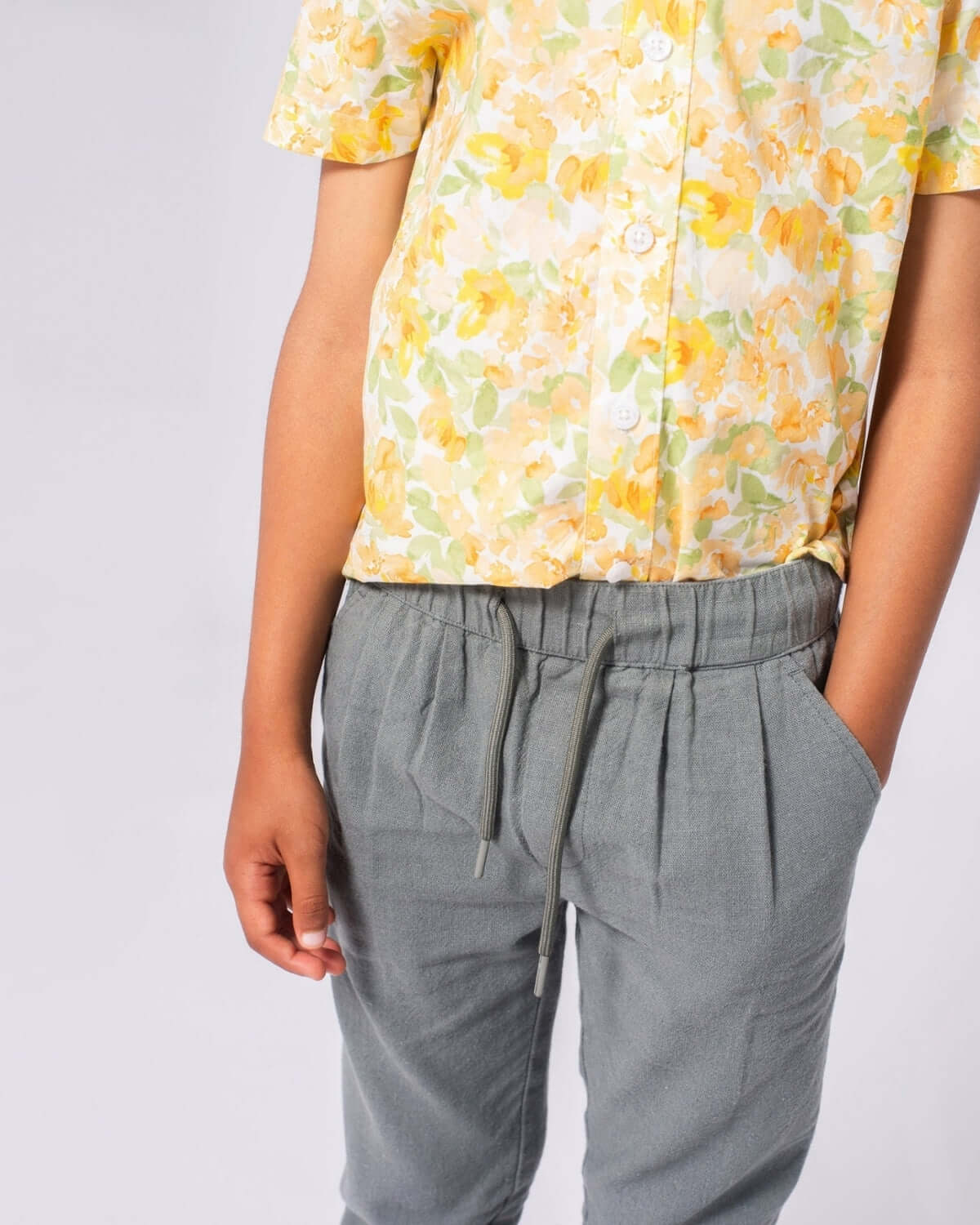 Stylish kid rocking the Sage Linen Resort Pant with a vibrant floral shirt—perfect for school and weekend adventures!