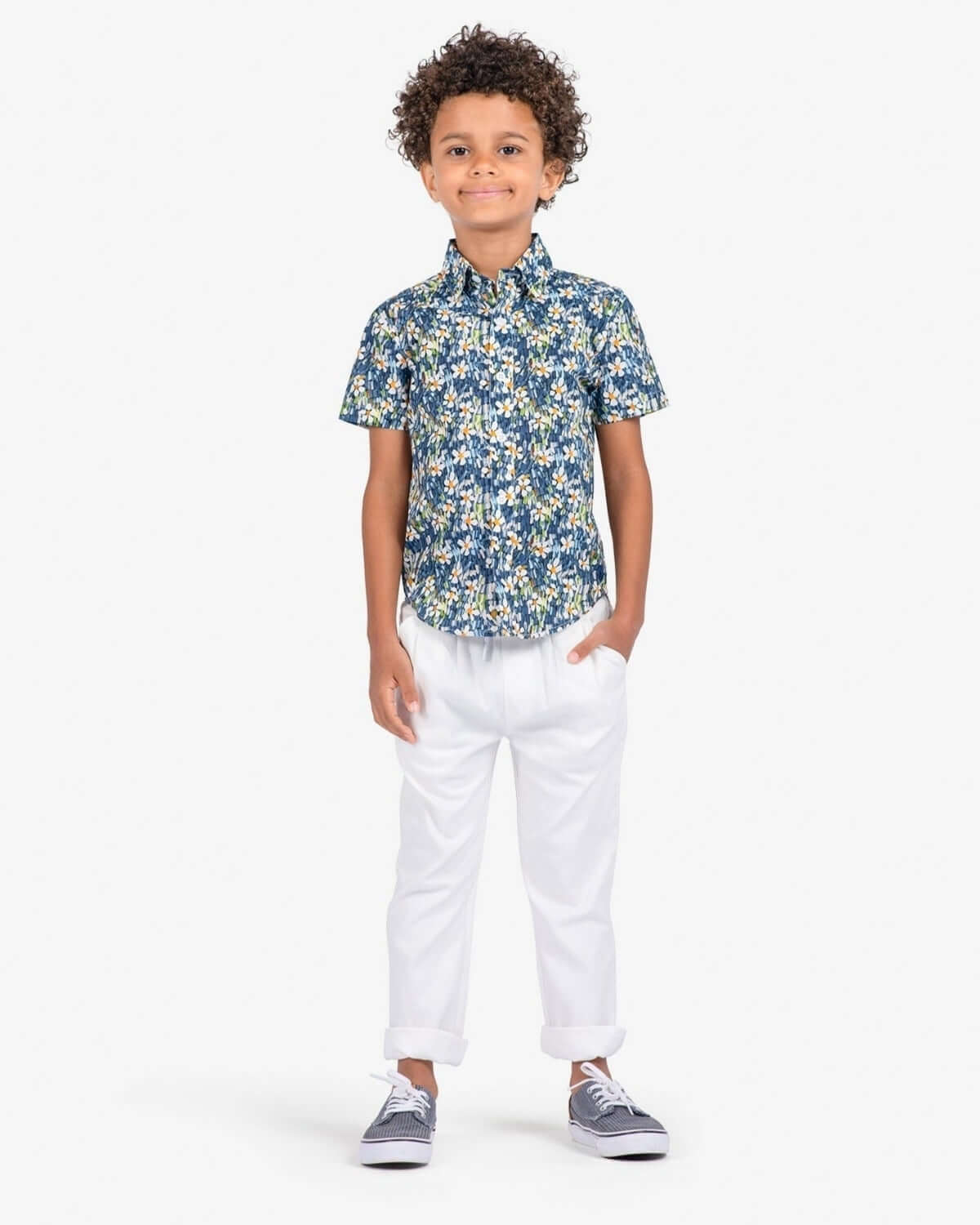 Boy wearing a floral shirt with White Resort Pants, showcasing a stylish summer outfit.