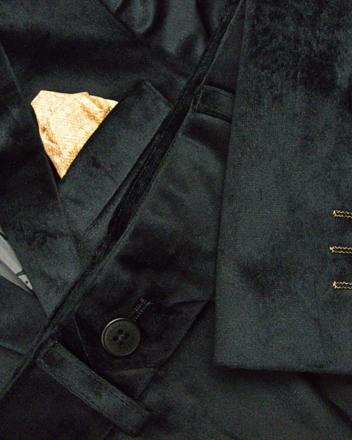 Sleek black velvet blazer with a stylish golden pocket square—perfect for chic kids' holiday gatherings!