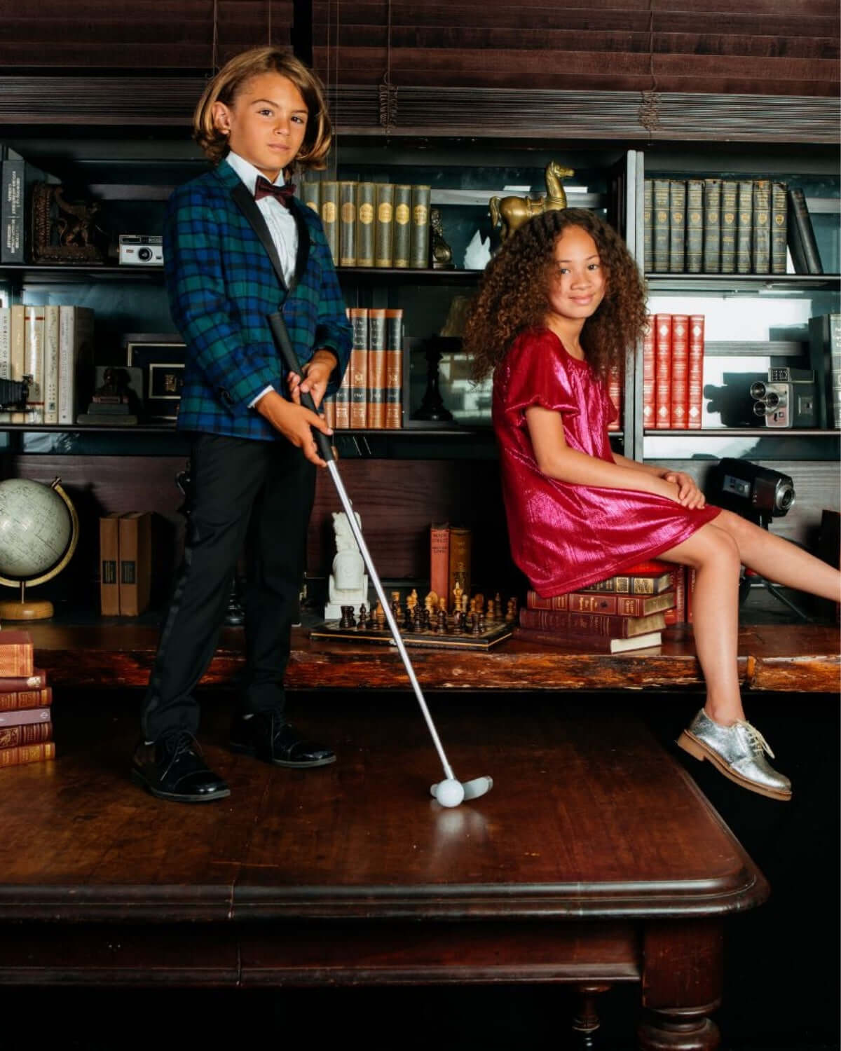 Stylish kids in a Blackwatch plaid tuxedo jacket and a pink dress, showcasing high-quality boys and girls clothes.