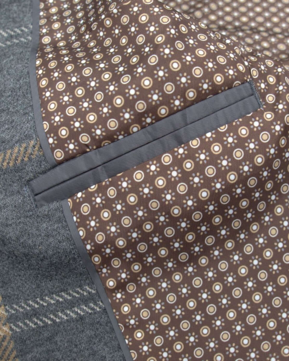 Close-up of the stylish interior lining of Appaman's Smoky Windowpane Club Jacket, featuring playful dotted patterns.
