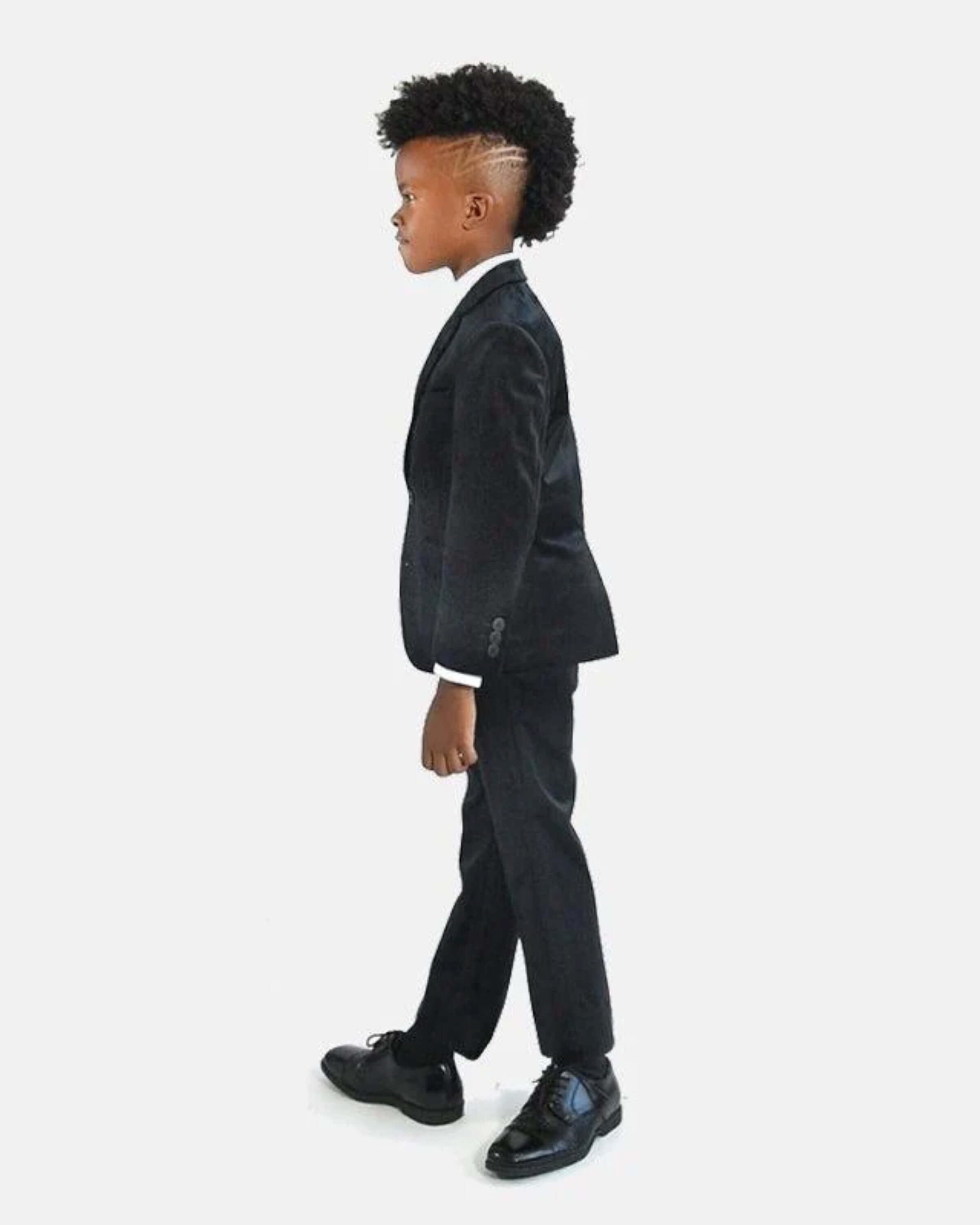 Stylish kid in a black velvet suit blazer, ready to shine at holiday parties—fashionable and fun for kids' special occasions!