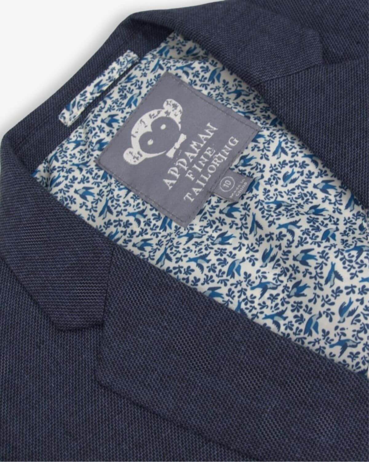 Inside view of the stylish Blue Nights Linen Sports Jacket featuring playful floral lining and Appaman branding.