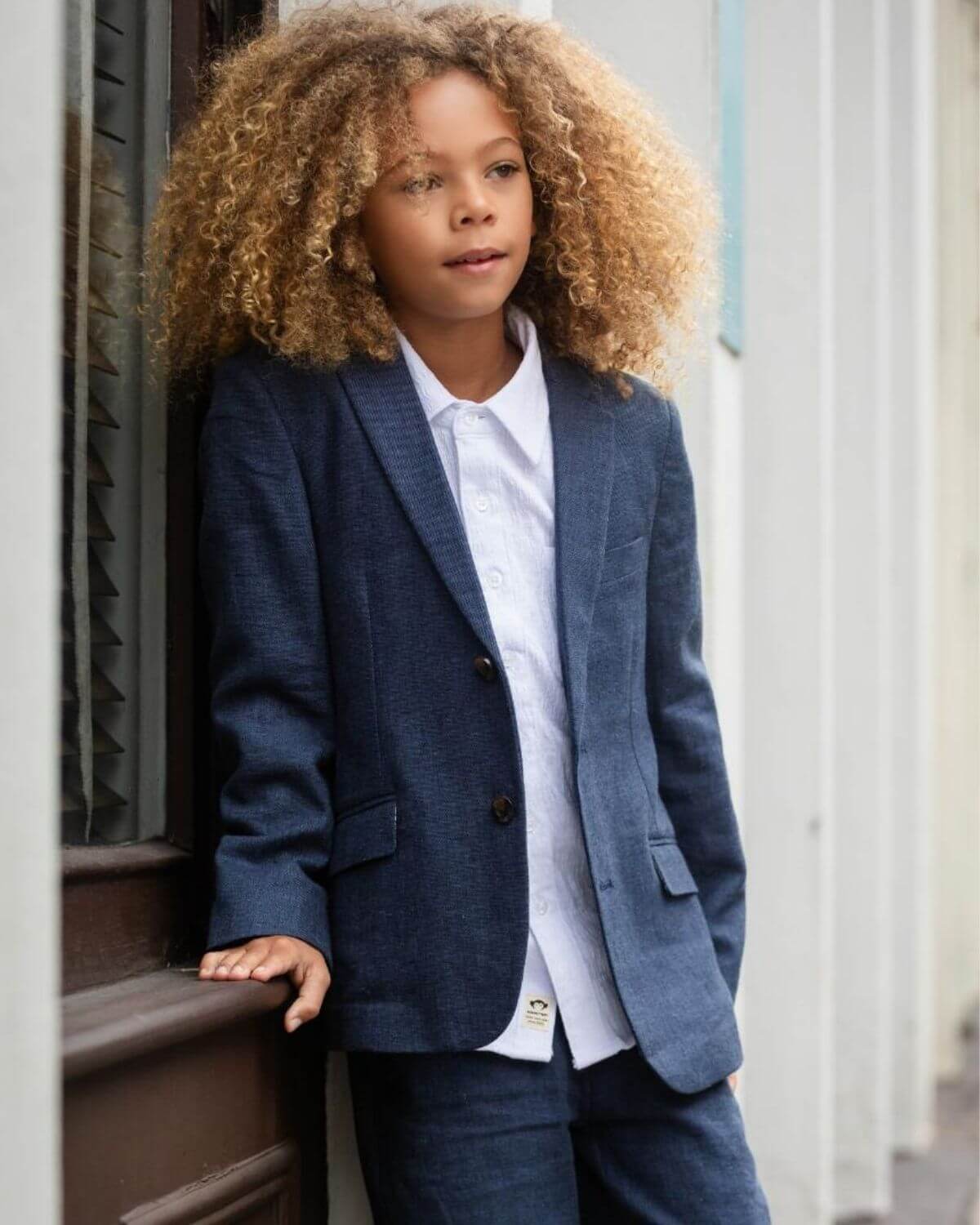 A child wearing a Blue Nights Linen Sports Jacket, showcasing a stylish look with a white shirt.
