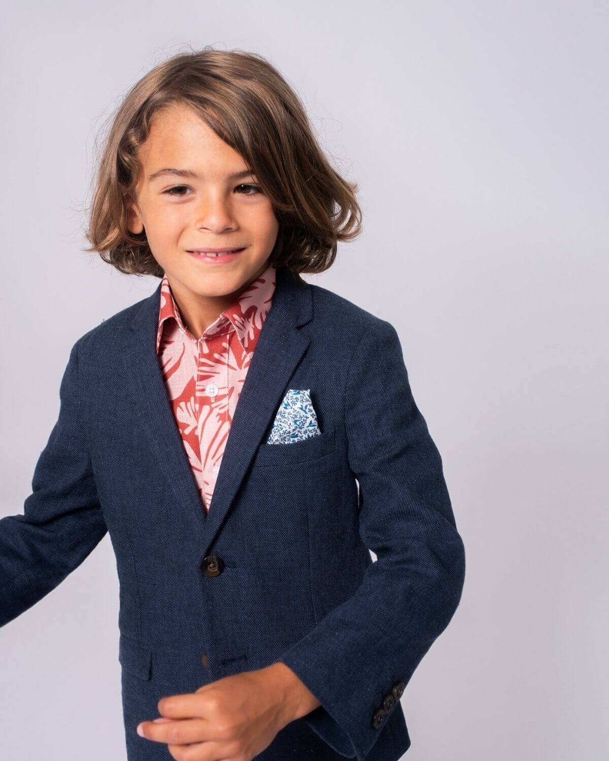 Stylish boy in a Blue Nights Linen Sports Jacket, showing off a vibrant shirt and pocket square—perfect for kids' fashion!