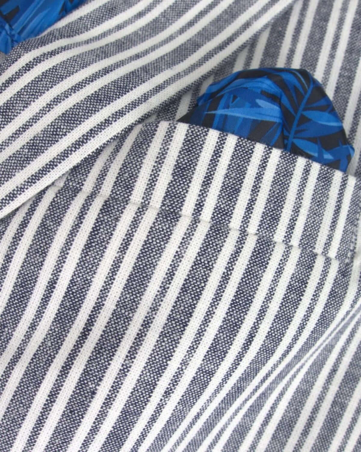 Close-up of navy stripe linen jacket with a stylish blue patterned pocket square for trendy kids' fashion.