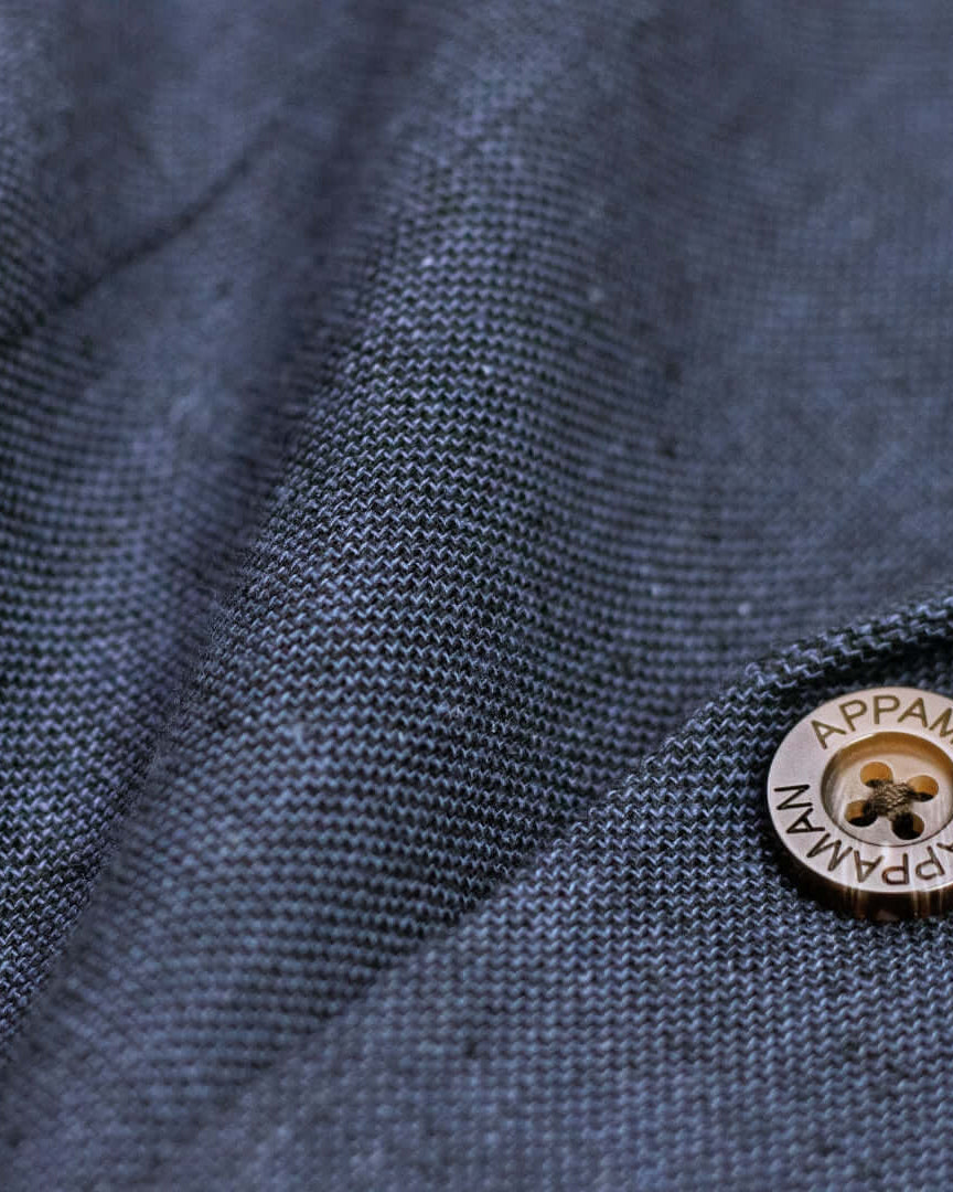 Close-up of Appaman's stylish Blue Nights linen fabric with a modern button—high quality kids clothes for chic back-to-school looks.