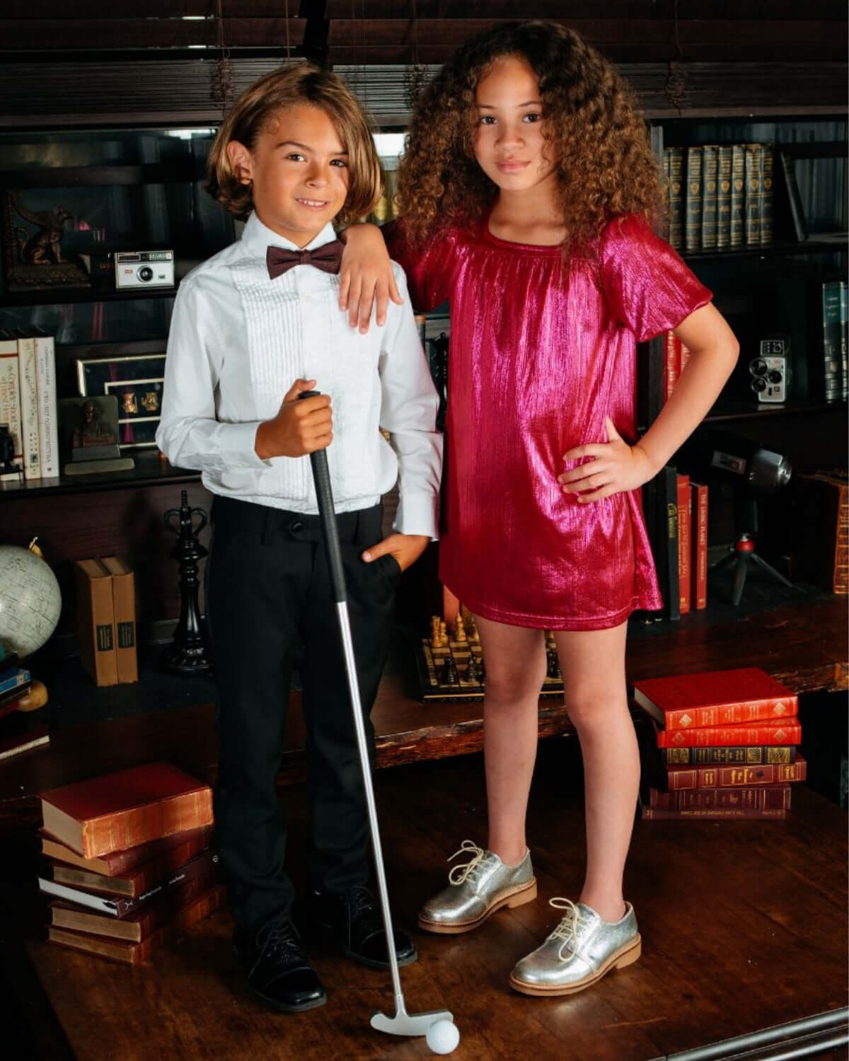 Two children in formal attire featuring Black Tuxedo Pants and stylish accessories for a classy look.