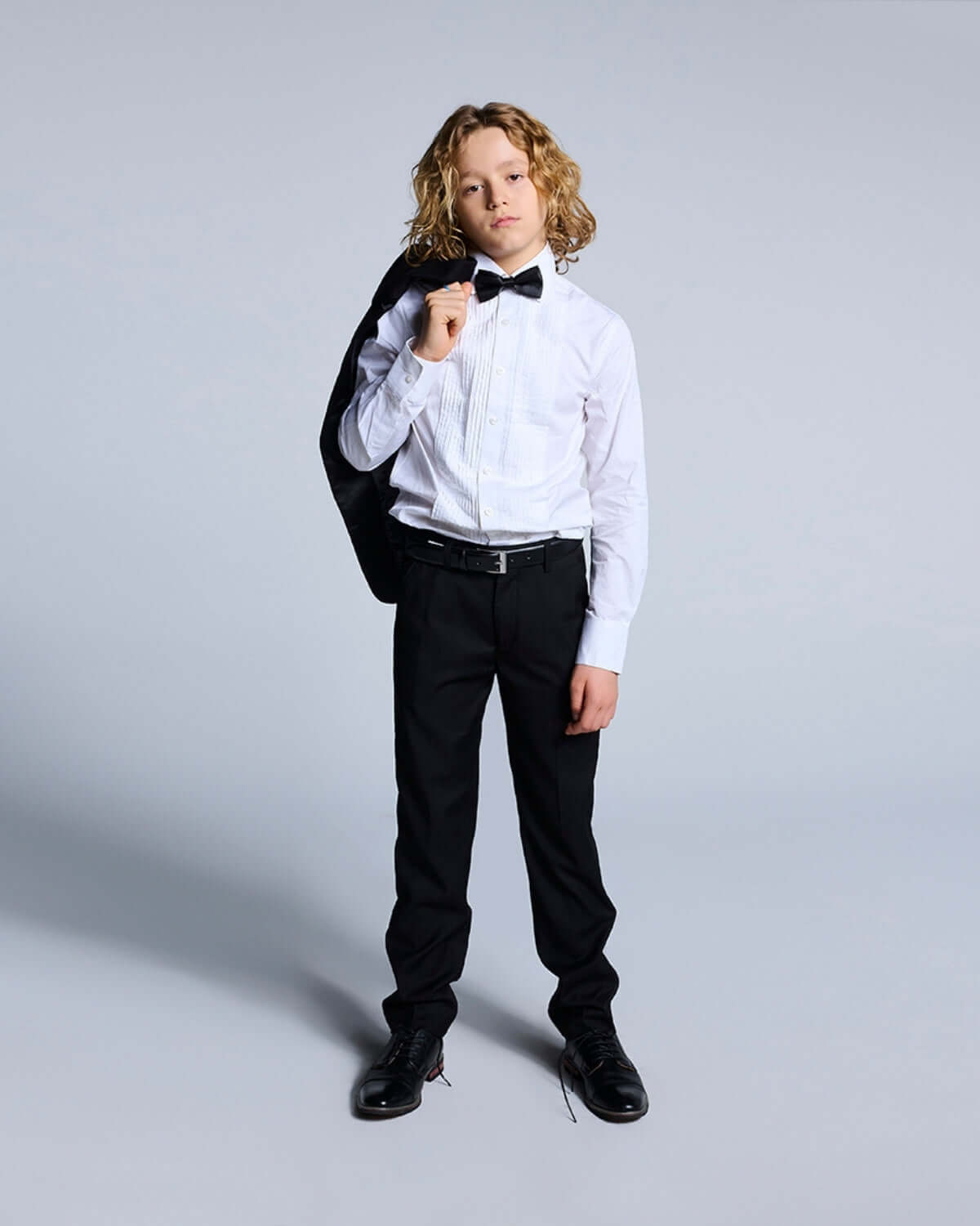 Little boy in a tuxedo with Black Tuxedo Pants, bow tie, and formal shirt, perfect for Black Tie events.
